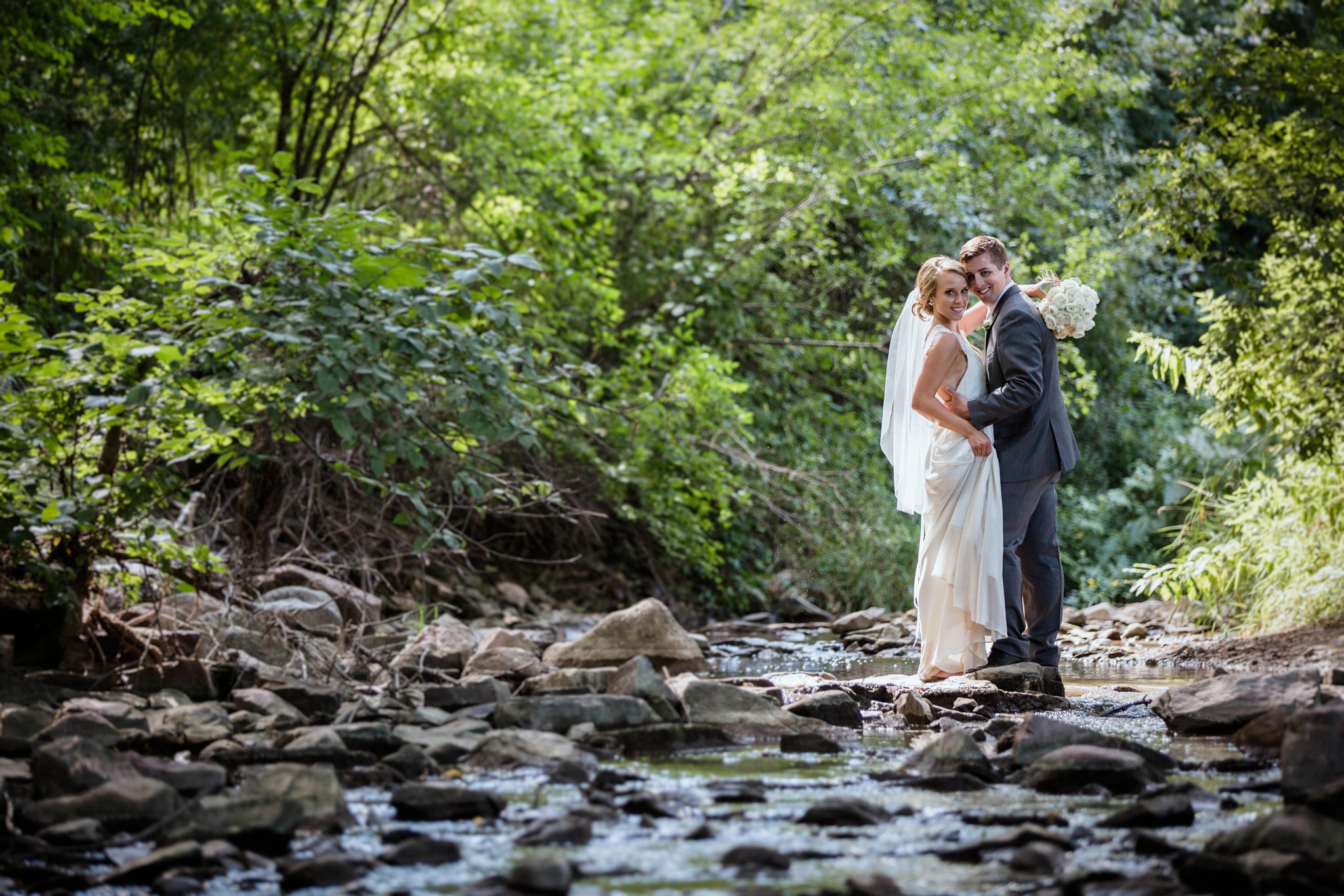 Sioux Falls Wedding Photos | Destination Photographer | Felicia The Photographer | Mary Jo Wegner Arboretum | bride and groom pose | boho bridal style | Standing in a creek