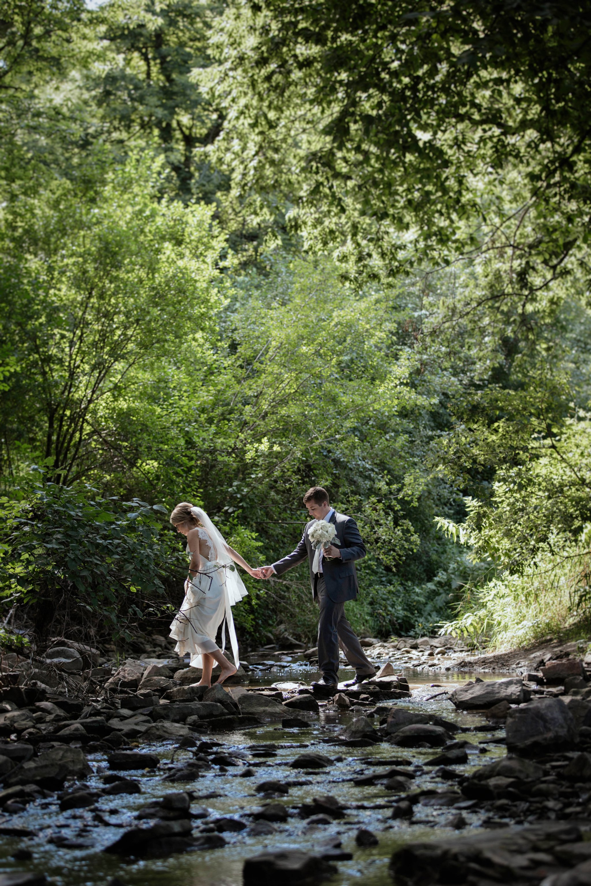 Sioux Falls Wedding Photos | Destination Photographer | Felicia The Photographer | Mary Jo Wegner Arboretum | bride and groom pose | boho bridal style | crossing a creek