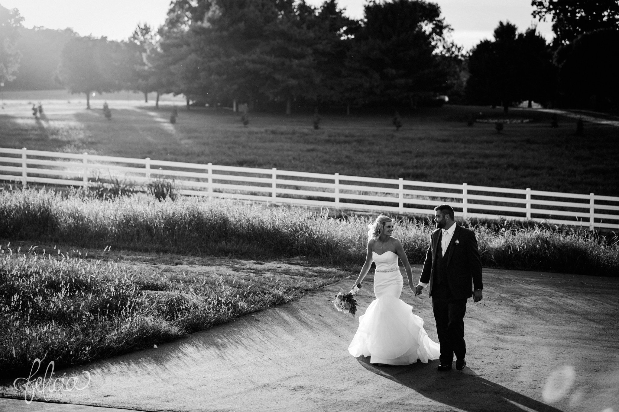 Bride and Groom | Photography | Black and White | Walking | White Picket Fence | Eighteen Ninety | Kansas City Wedding Venue | Felicia The Photographer