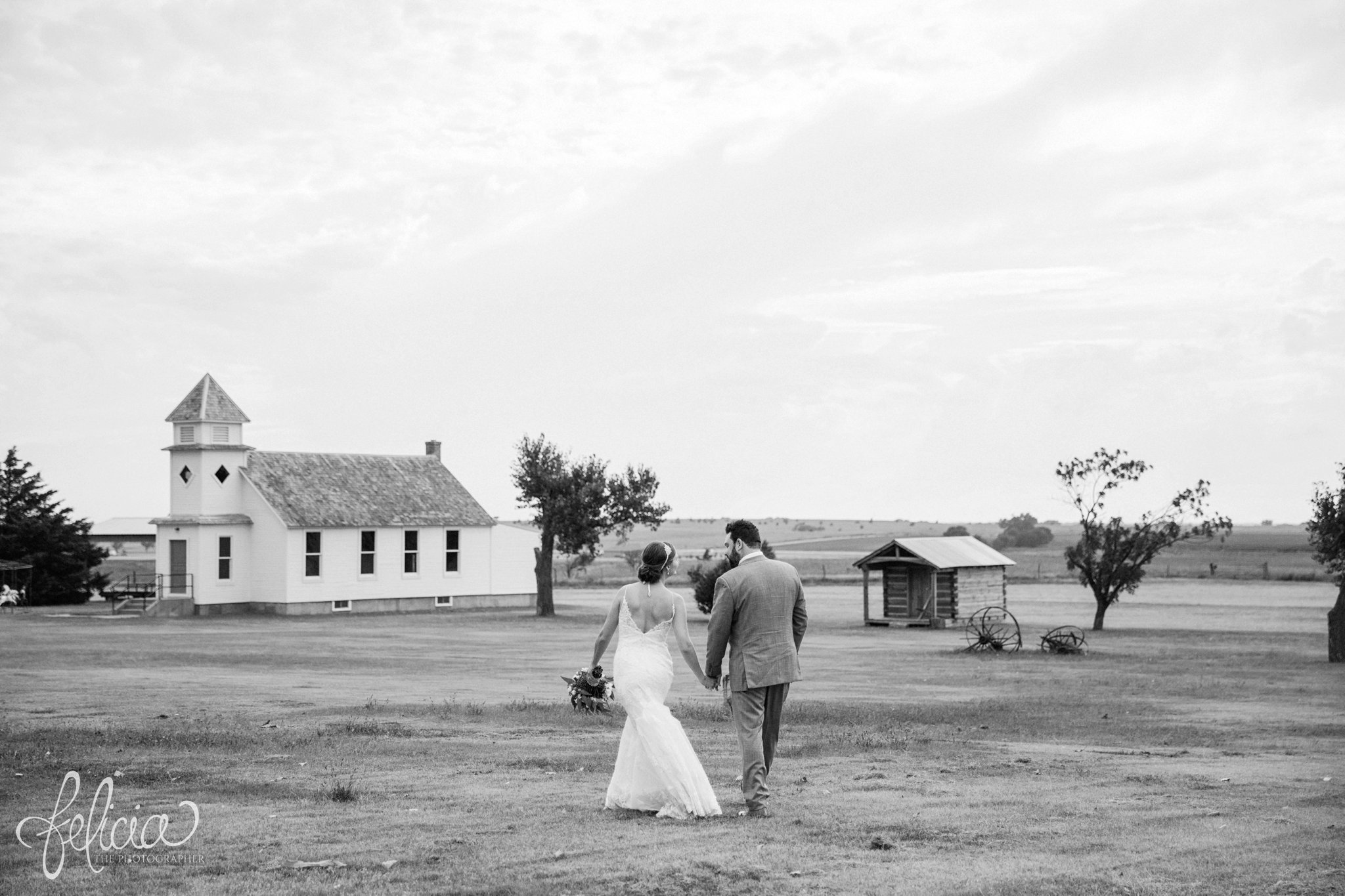 Black and White | Wedding | Wedding Photography | Wedding Photos | Travel Photographer | Images by feliciathephotographer.com | Kansas | Bride and Groom Portrait | Candid | Walking in Field | Chapel | Holding Hands 