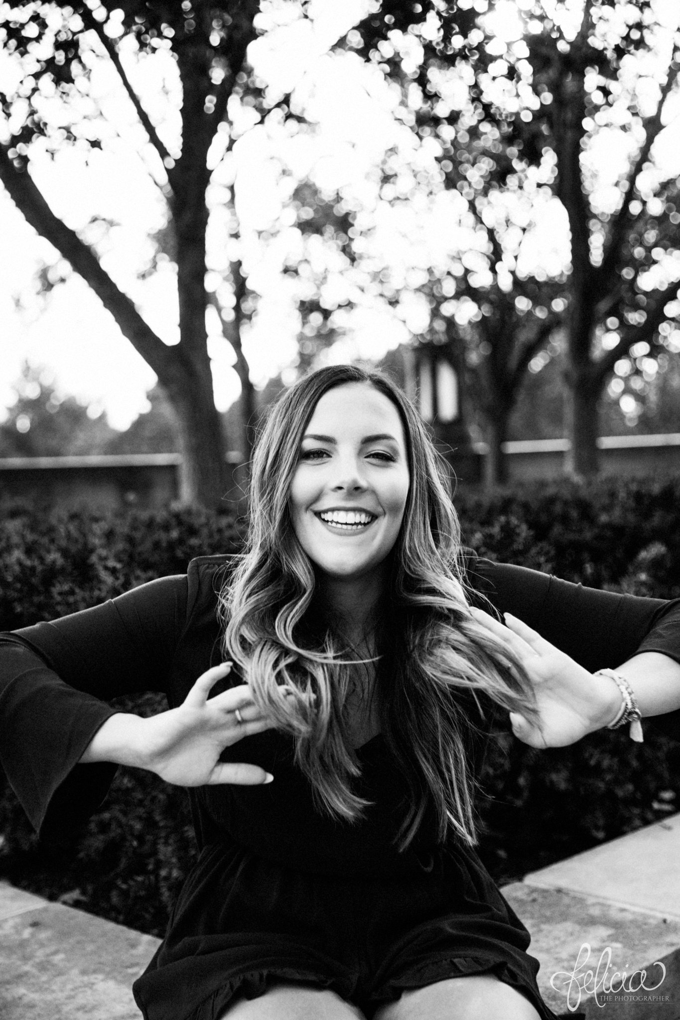 black and white | senior pictures | Kansas City | senior photos | senior photography | images by feliciathephotographer.com | crossed arms | navy romper | long sleeved | sun flare | nature | natural | candid | fixing hair | laughter 