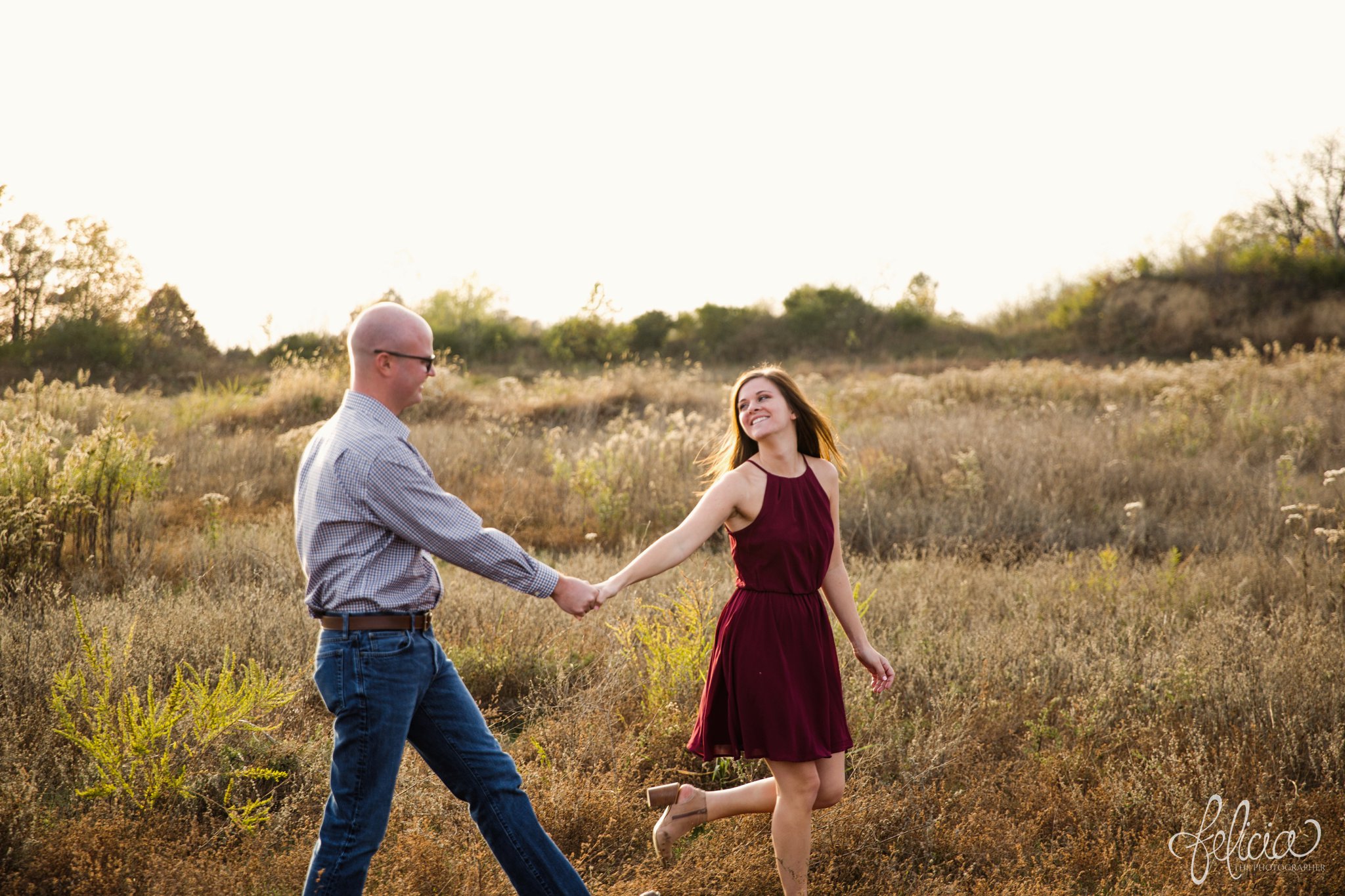 engagement pictures | engagement photos | nature | golden hour | sunset | sunset photography | walking in a field | fall | autumn | burgundy | holding hands | stroll 