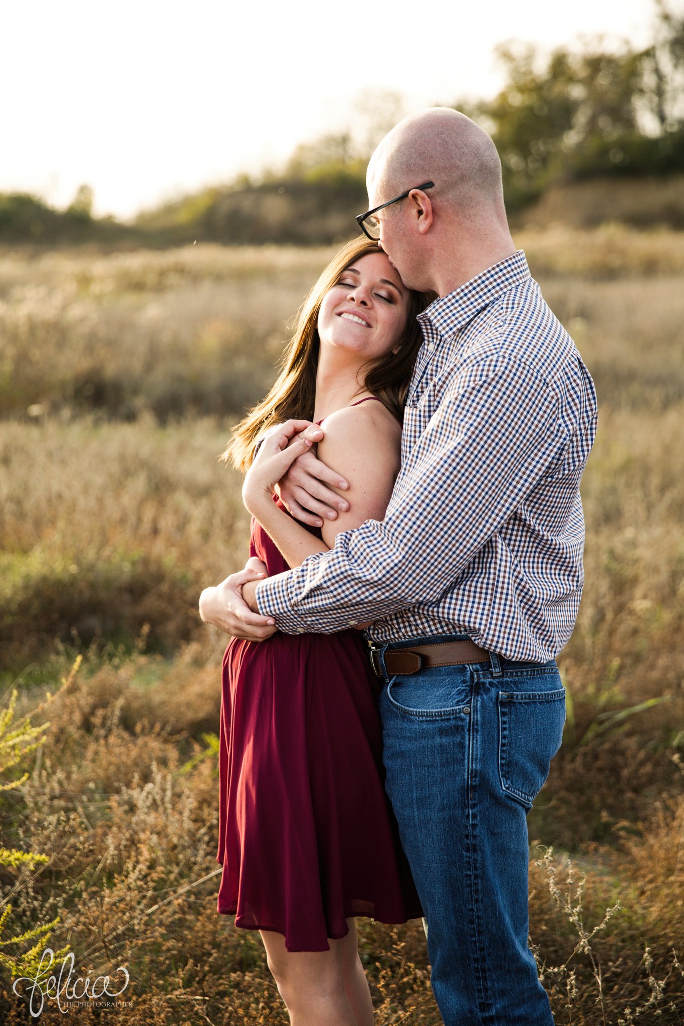 engagement pictures | engagement photos | nature | golden hour | sunset | sunset photography | fall | autumn | burgundy | cuddling | head kiss | closed eyes | sweet smiles | field