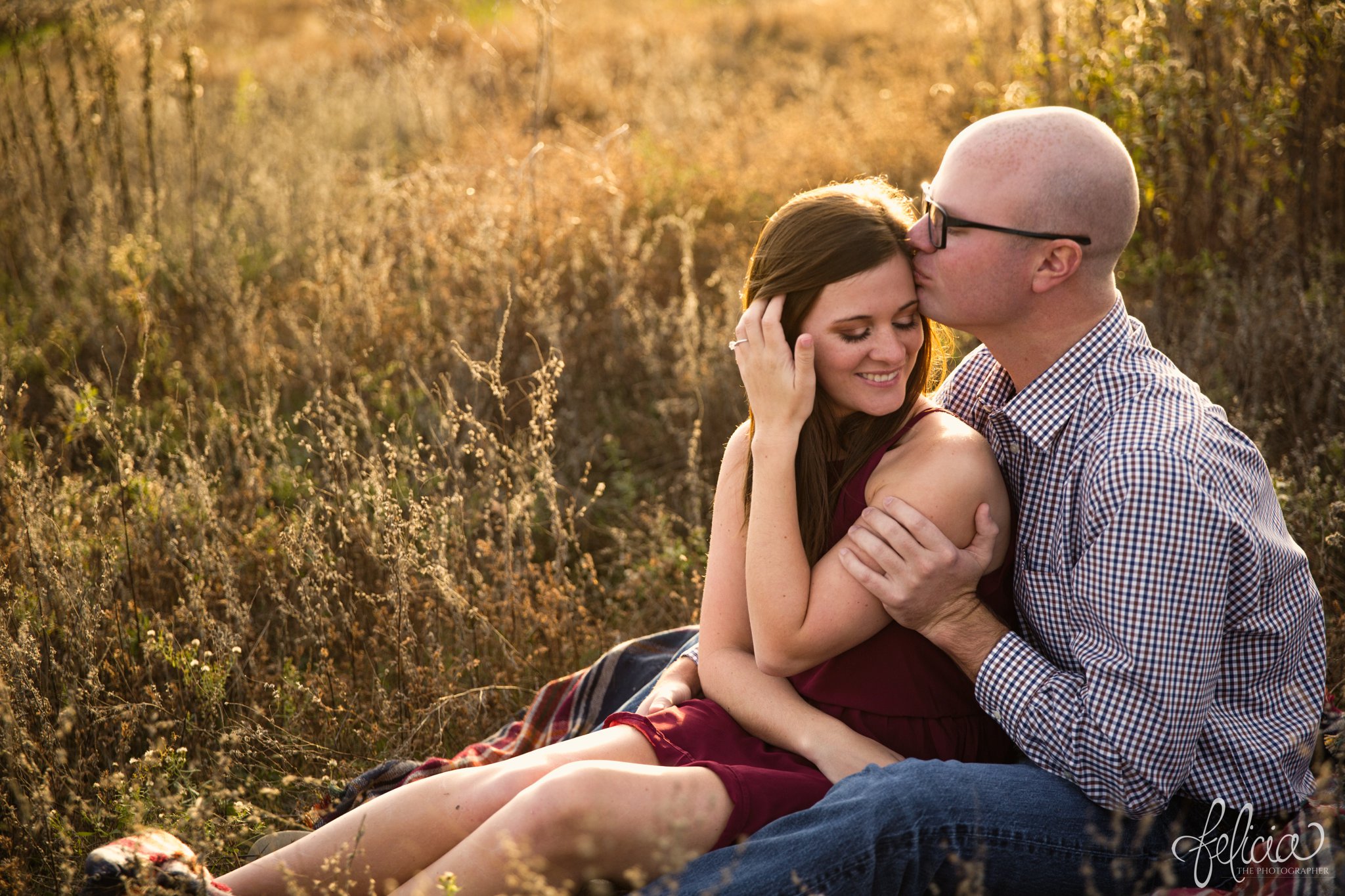 engagement pictures | engagement photos | nature | golden hour | sunset | sunset photography | fall | autumn | burgundy | laying in a field | lounging | sun flare | casual poses | picnic | forehead kiss