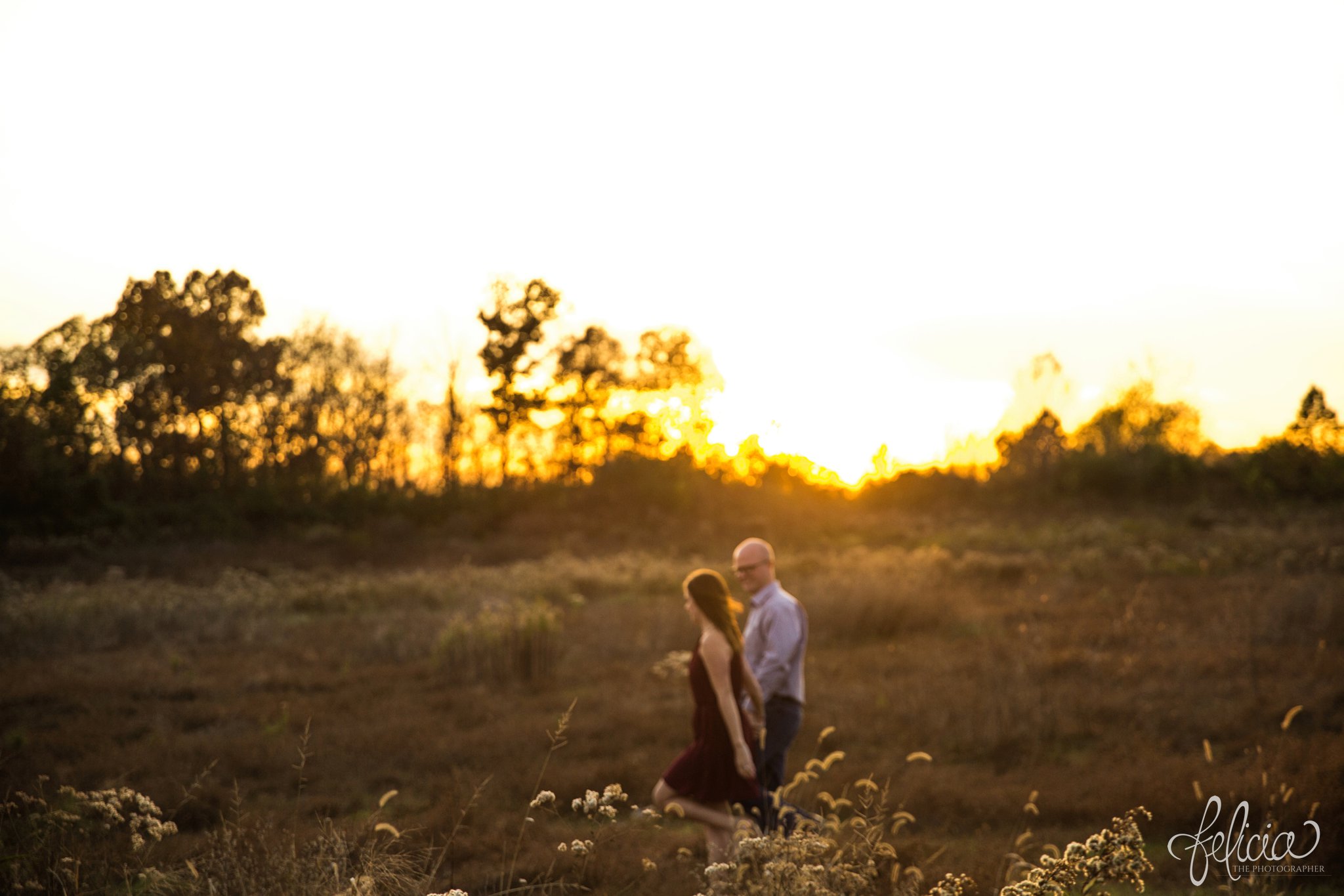 engagement pictures | engagement photos | nature | golden hour | sunset | sunset photography | fall | autumn | burgundy | natural | sun flare | nature background | holding hands | walking in a field 