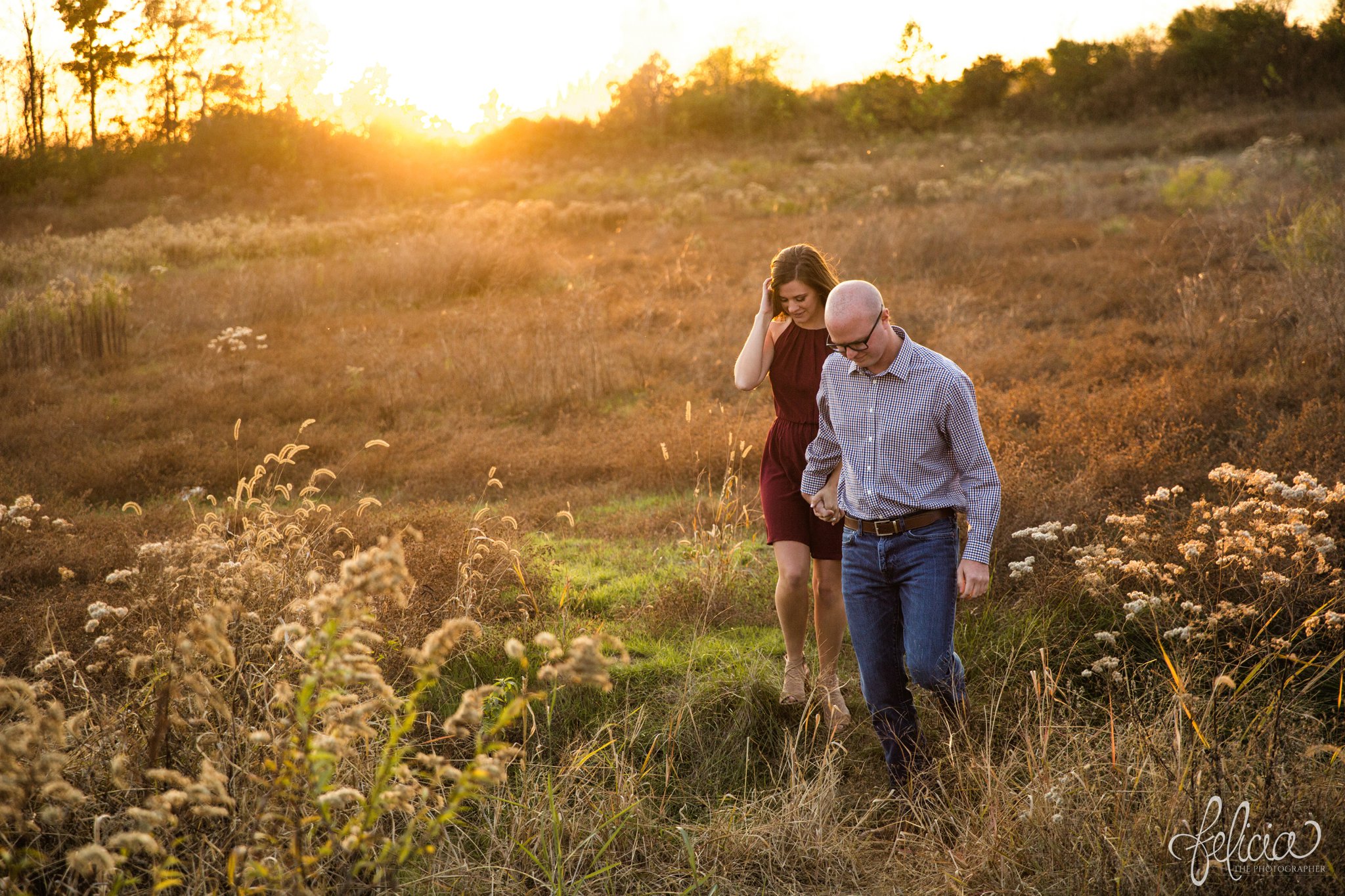 engagement pictures | engagement photos | nature | golden hour | sunset | sunset photography | fall | autumn | burgundy | natural | sun flare | nature background | holding hands | walking in a field 