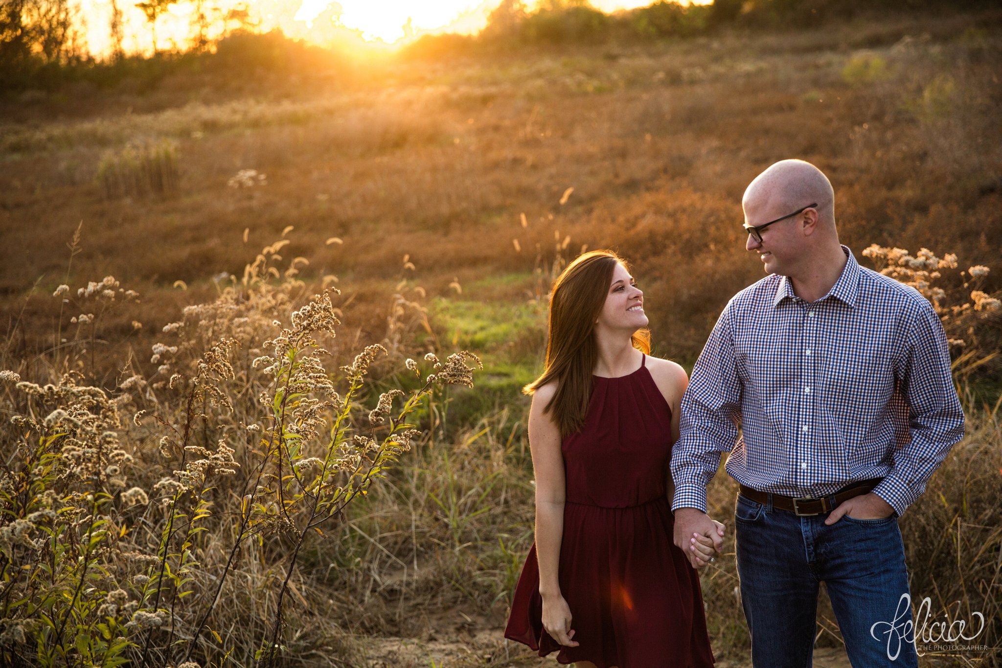 engagement pictures | engagement photos | nature | golden hour | sunset | sunset photography | fall | autumn | burgundy | natural | sun flare | nature background | candid | smiles | holding hands 