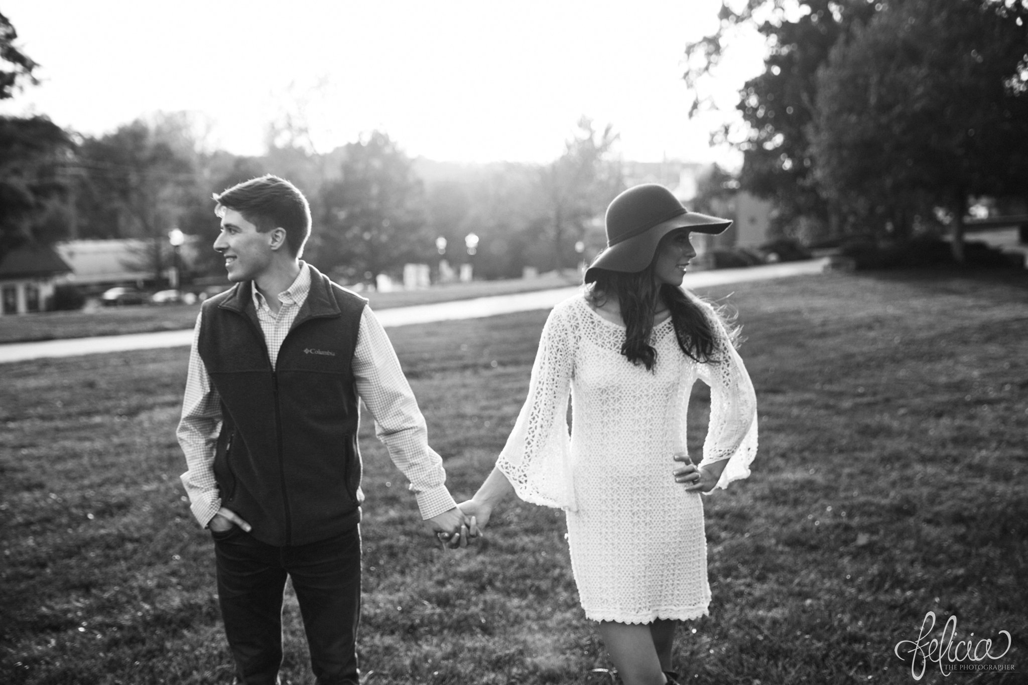 Black and White | Engagement Photos | Engagement Photography | Sunset | Sunset Photography | Felicia the Photographer | Images by feliciathephotographer.com | Fall | Autumn | Lake | Sun Flare | Holding Hands | Floppy Hat 