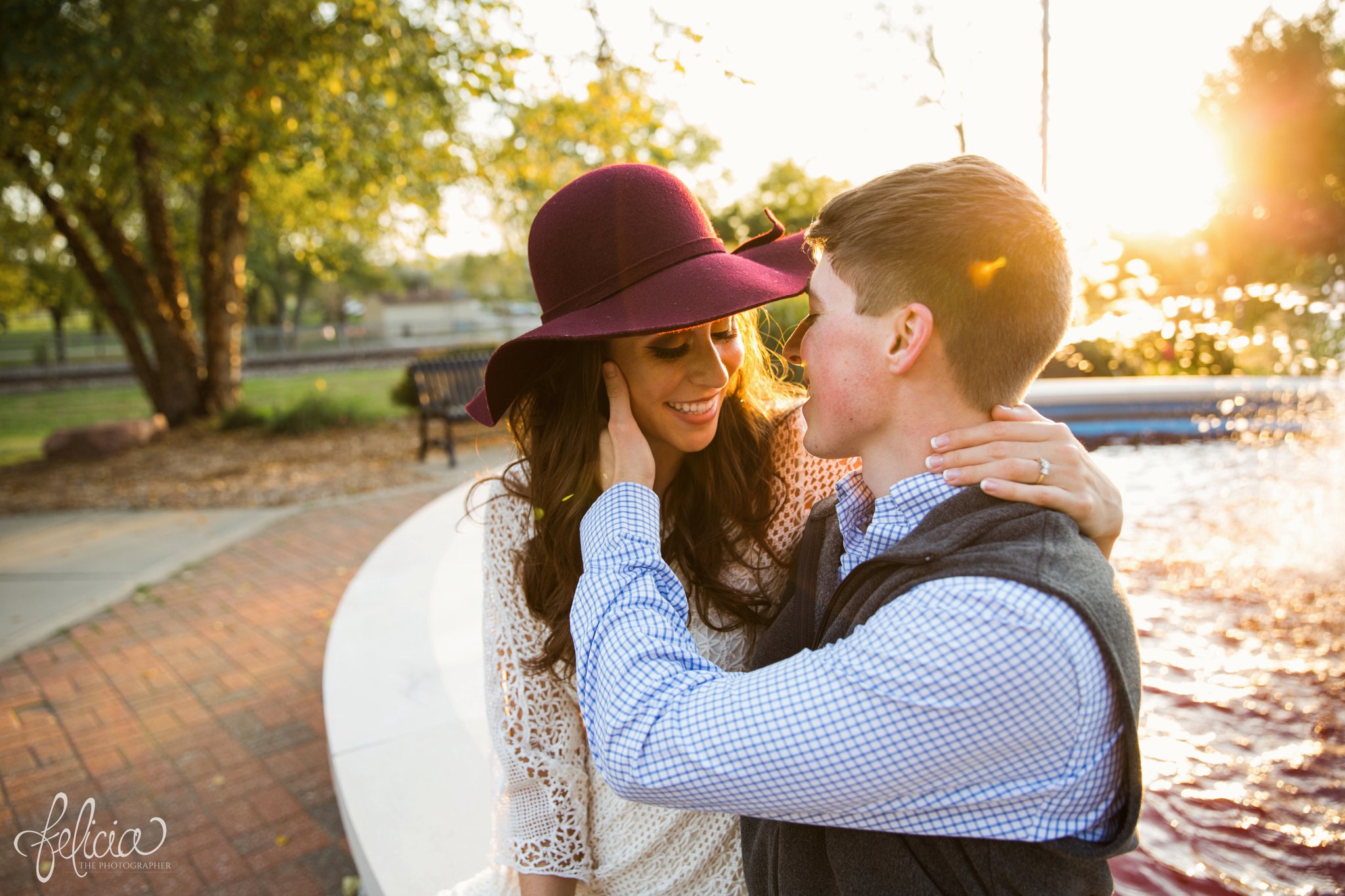 Engagement Photos | Engagement Photography | Sunset | Sunset Photography | Felicia the Photographer | Images by feliciathephotographer.com | Fall | Autumn | Lake | Sun Flare | Floppy Hat | Regal | Elegant | Hand on Cheek | Cuddling | Smiles | Fountain 