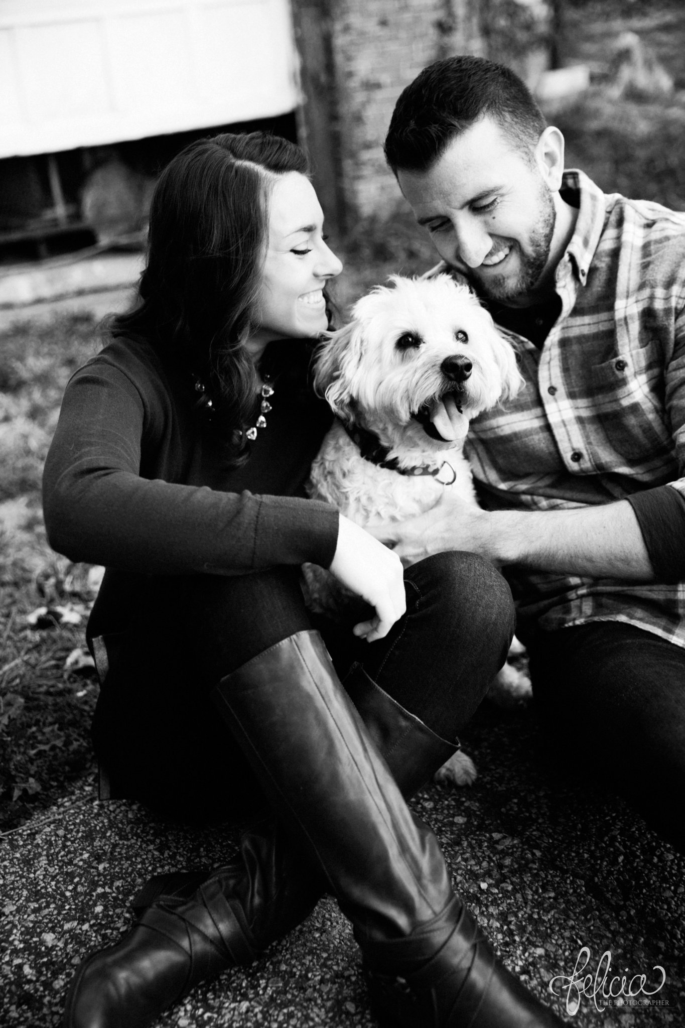 black and white | engagement photos | engagement photography | Kansas City | West Bottoms | images by feliciathephotographer.com | urban setting | industrial background | candid | engagement photos with dog | terrier | smiling bride 