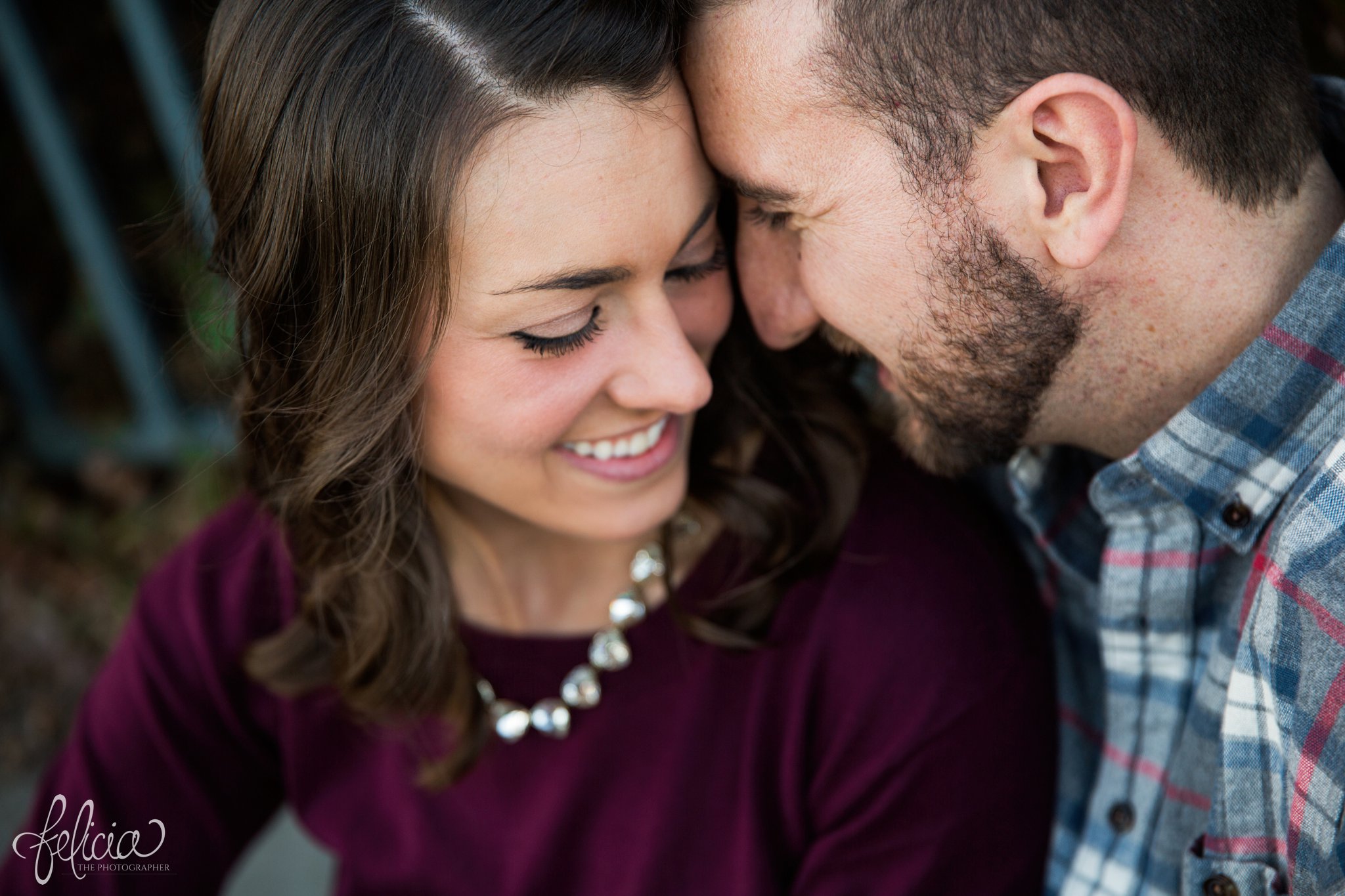 images by feliciathephotographer.com | engagement photos | engagement photography | Kansas City | West Bottoms | images by feliciathephotographer.com | urban setting | industrial background | cuddling | close up | candid smiles 