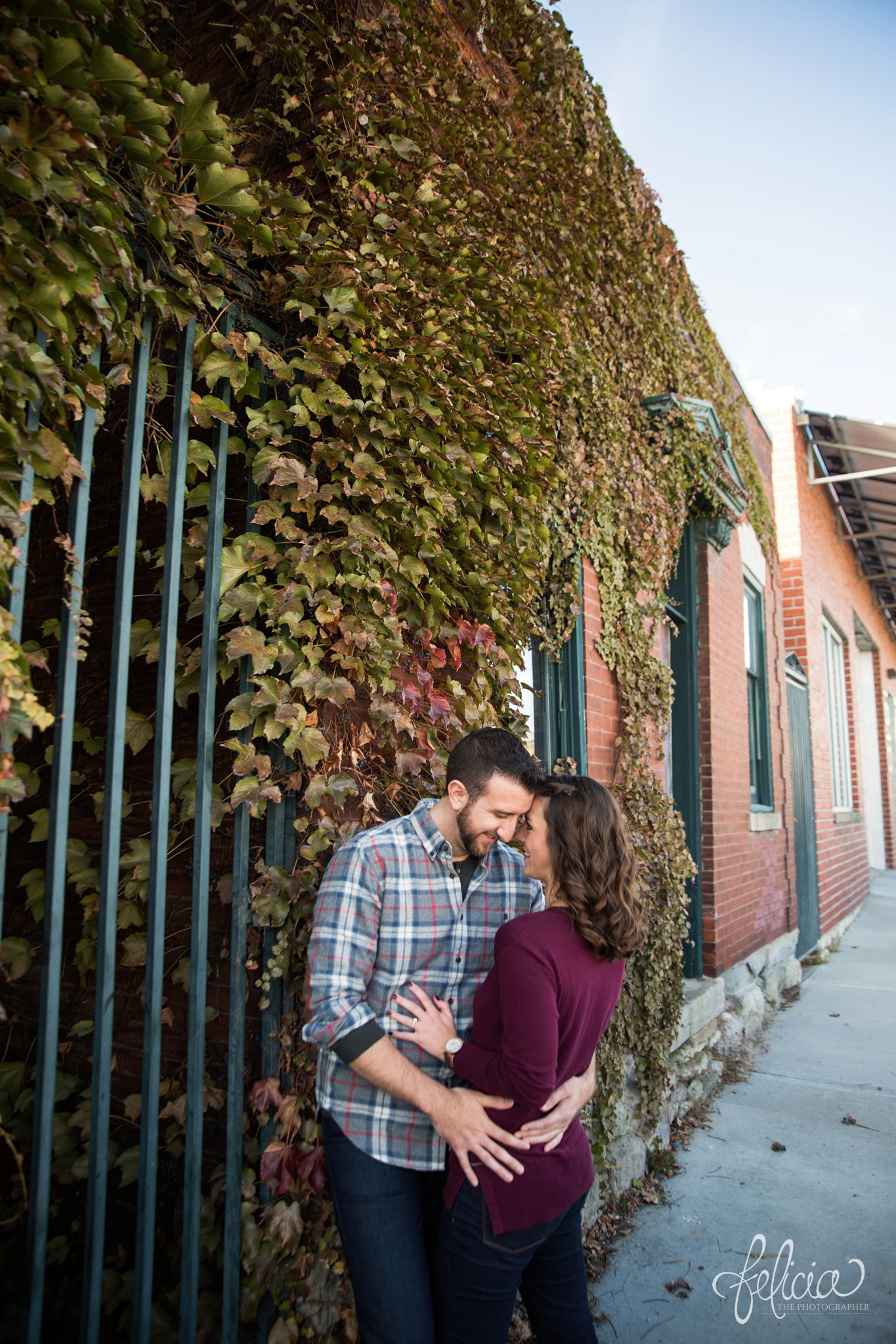 images by feliciathephotographer.com | engagement photos | engagement photography | Kansas City | West Bottoms | images by feliciathephotographer.com | urban setting | industrial background | ivy brick wall | hugging 