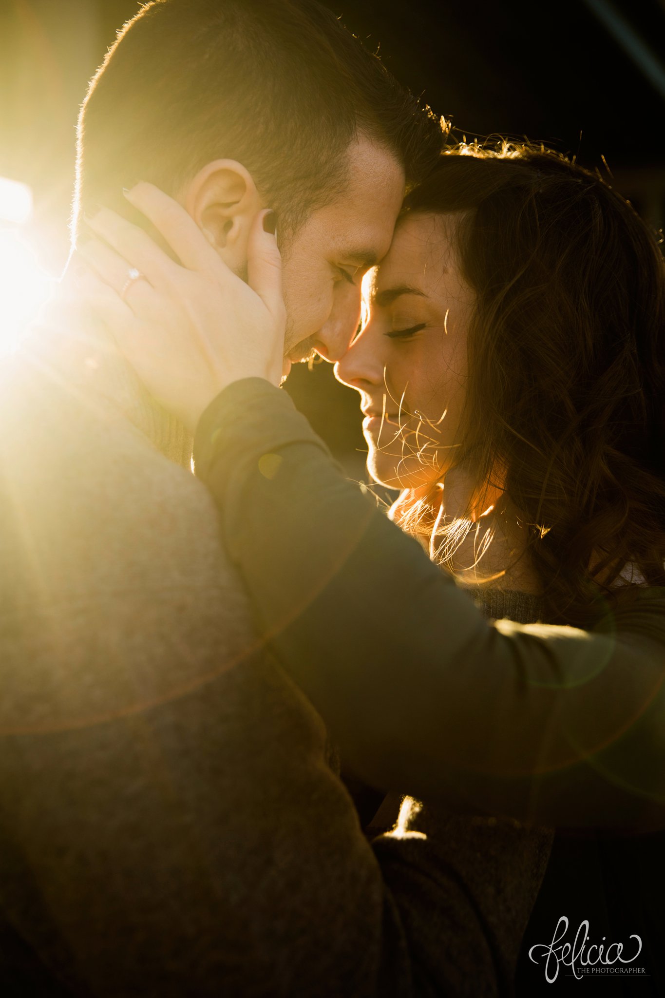 engagement photos | engagement photography | Kansas City | West Bottoms | images by feliciathephotographer.com | urban setting | industrial background | sun flare | romantic pose | head shot | close up | closed eyes | happy 