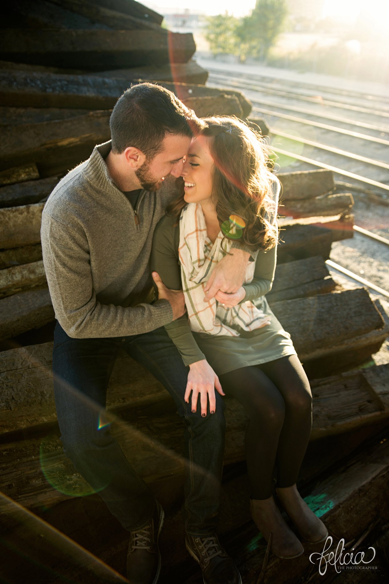 engagement photos | engagement photography | Kansas City | West Bottoms | images by feliciathephotographer.com | urban setting | industrial background | engagement shoot | candid | hand on cheek | sun flare | laughing | cuddling | smiles 