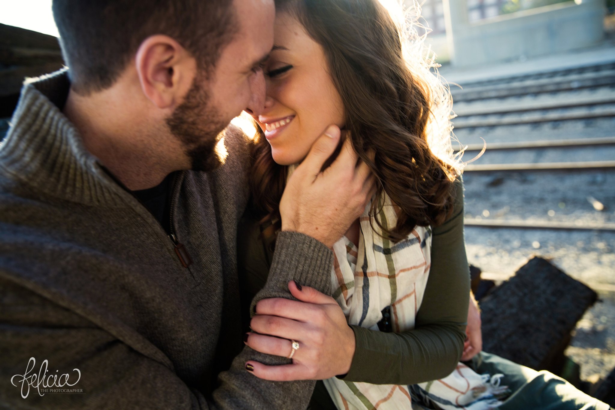 engagement photos | engagement photography | Kansas City | West Bottoms | images by feliciathephotographer.com | urban setting | industrial background | engagement shoot | candid | hand on cheek | engagement ring | gold band 