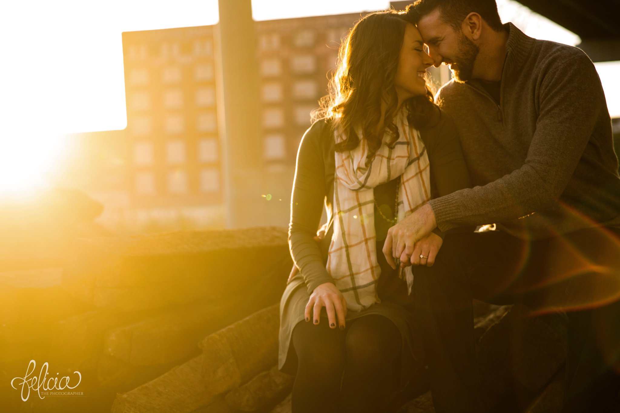 engagement photos | engagement photography | Kansas City | West Bottoms | images by feliciathephotographer.com | urban setting | industrial background | engagement shoot | sun flare | candid | laughter | forehead touch | overpass 