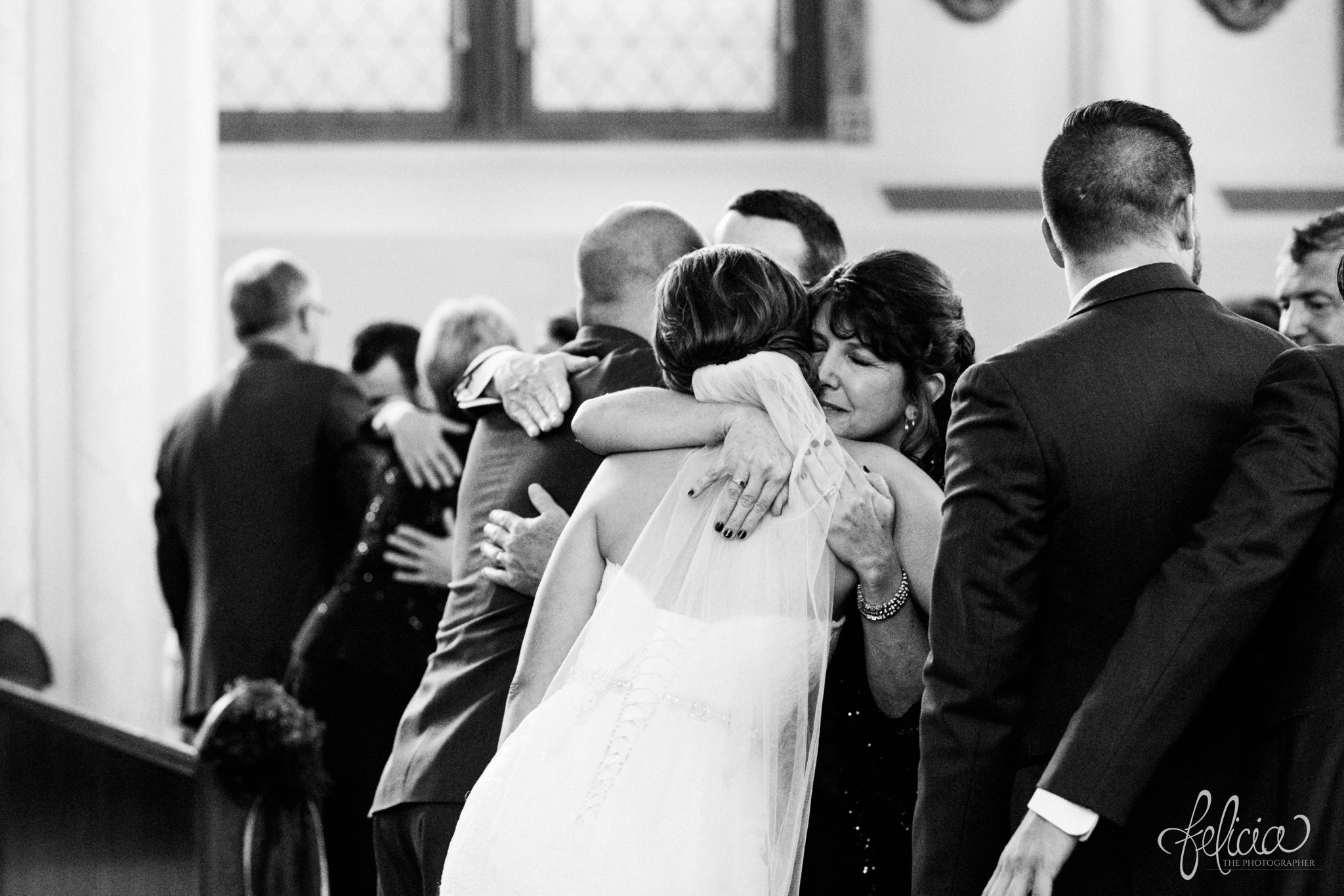 black and white | weddings | wedding photography | wedding photos | images by feliciathephotographer.com | St. Francis Xavier Church | Moila Country Club | autumn wedding | fall wedding | fall colors | harvest | purple and orange | Kansas City | St. Joseph | harvest inspiration | wedding ceremony | emotions | tears | candid | mother of the bride | mother and bride | hug 