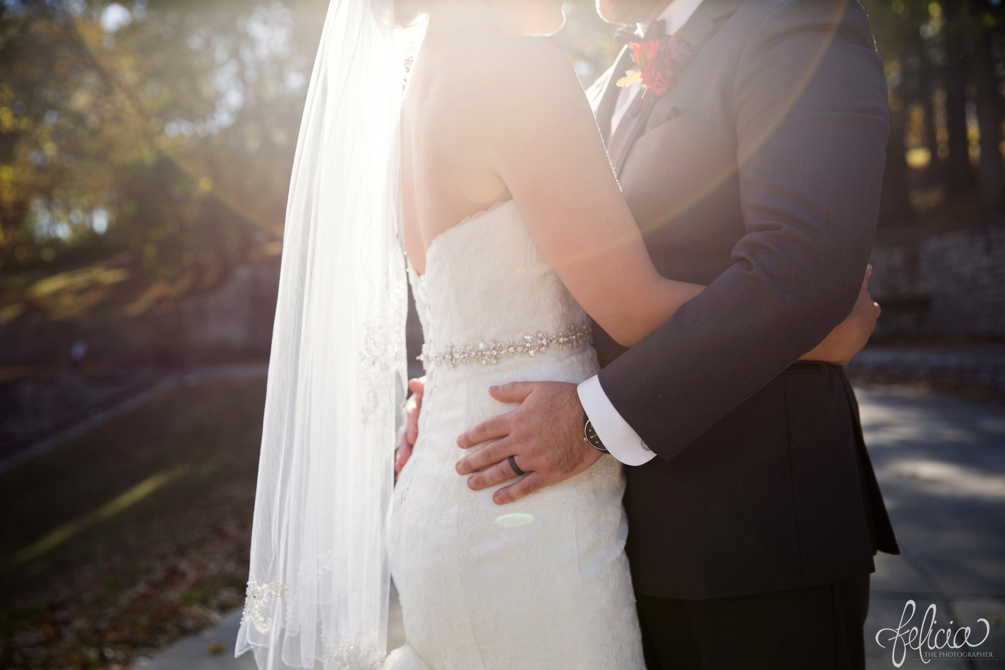 weddings | wedding photography | wedding photos | images by feliciathephotographer.com | St. Francis Xavier Church | Moila Country Club | autumn wedding | fall wedding | fall colors | harvest | purple and orange | Kansas City | St. Joseph | harvest inspiration | bride and groom portrait | outdoor | sunlight | hands on hips | sunlit veil | David's Bridal | black wedding band 