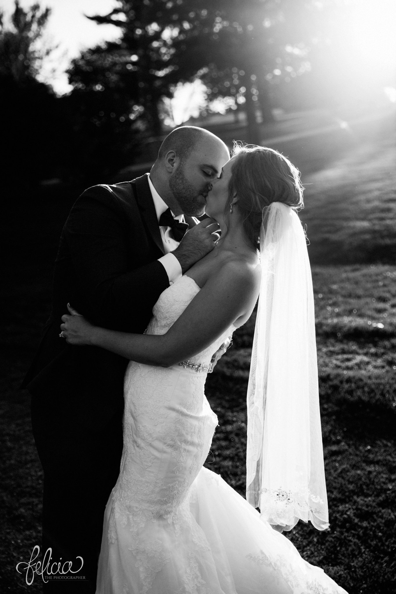 black and white | weddings | wedding photography | wedding photos | images by feliciathephotographer.com | St. Francis Xavier Church | Moila Country Club | autumn wedding | fall wedding | fall colors | harvest | purple and orange | Kansas City | St. Joseph | harvest inspiration | bride and groom portrait | outdoor | golden hour | sun flare | kiss | romantic pose | dip | David's Bridal 