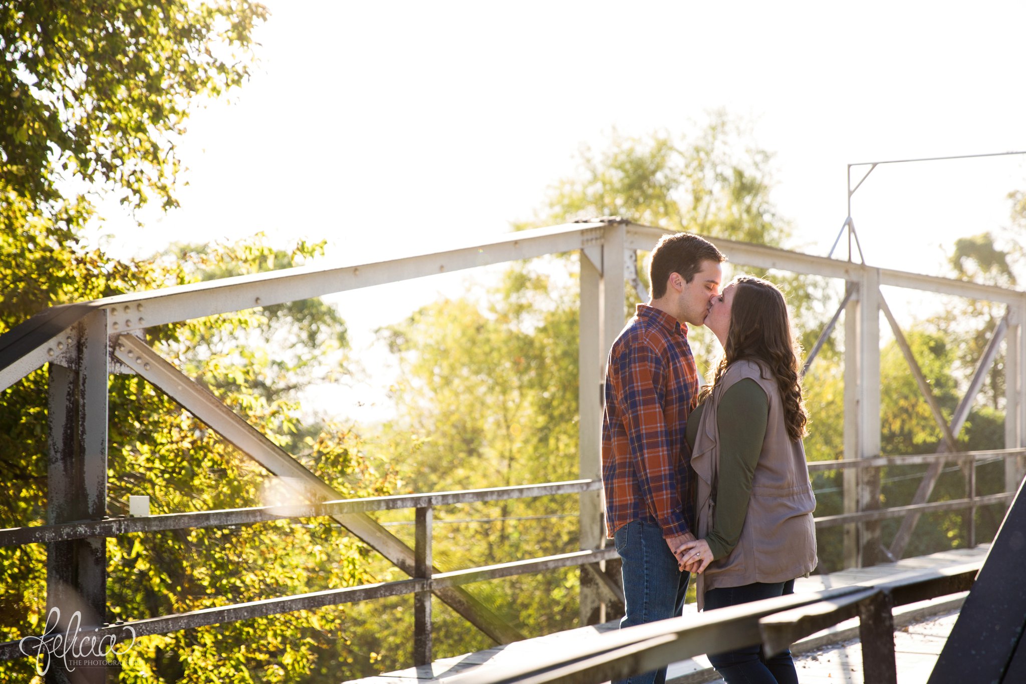 engagement photos | engagement photography | Felicia the Photographer | images by feliciathephotographer.com | sun flare | farm | nature | cowboy boots | kiss on bridge | kiss 