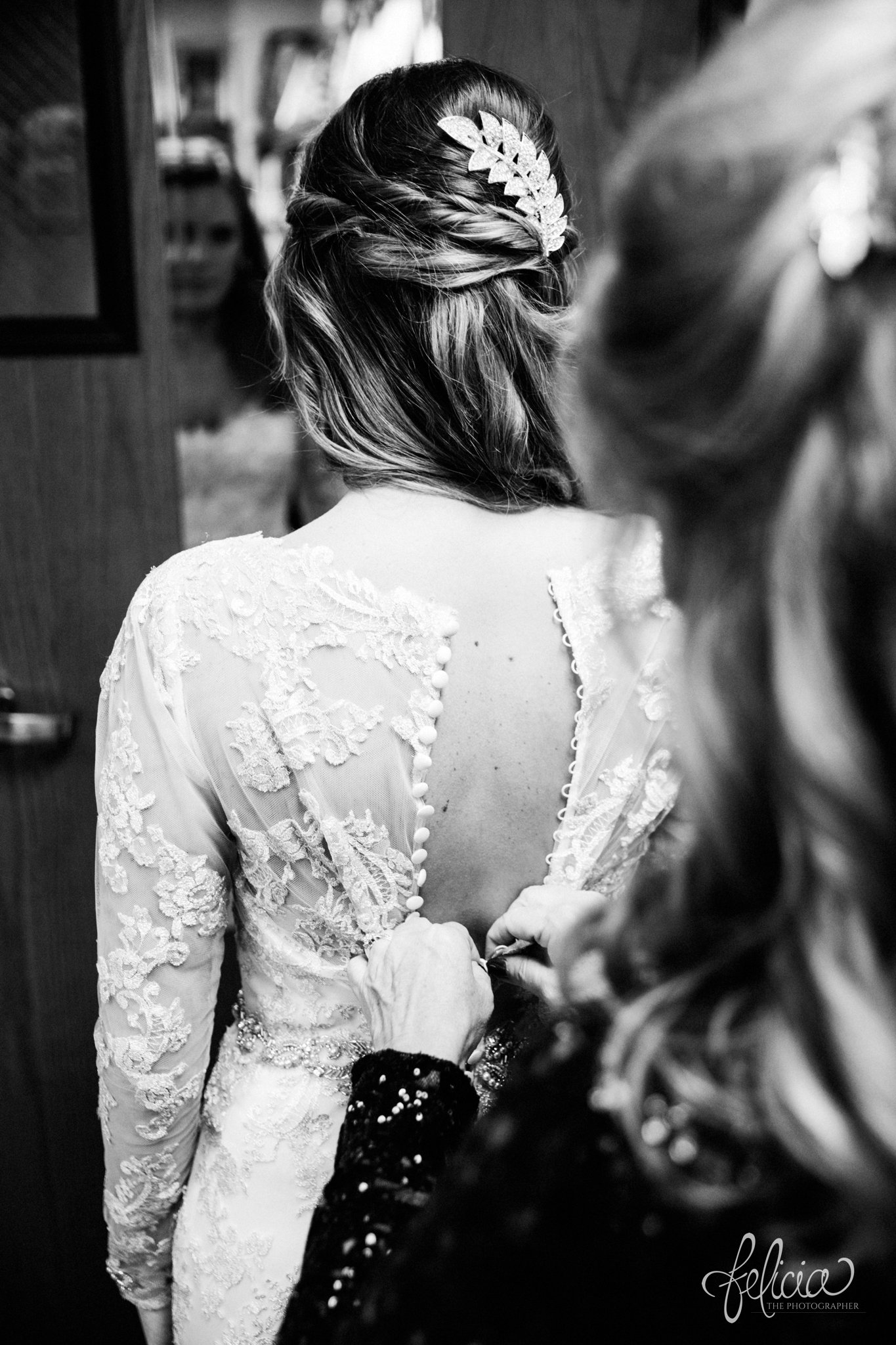black and white | weddings | wedding photos | wedding photography | images by feliciathephotographer.com | St. Therese Catholic Church | Kansas City | downtown | The Terrace on Grand | wedding prep | getting ready | hair accessories | feather | lace dress | satin buttons | bride and mother | mother of the bride | stepping into dress | wedding dress | White Carpet Bride | Maggie Sottero 