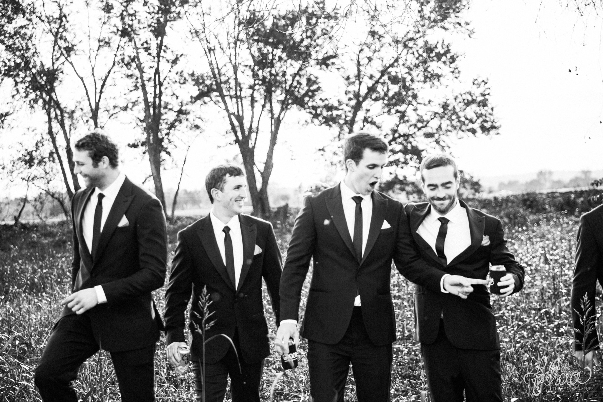 black and white | weddings | wedding photos | wedding photography | images by feliciathephotographer.com | St. Therese Catholic Church | Kansas City | downtown | The Terrace on Grand | bridal party portraits | grassy field | field | nature | candid | groomsmen portrait | funny groomsmen | The Black Tux