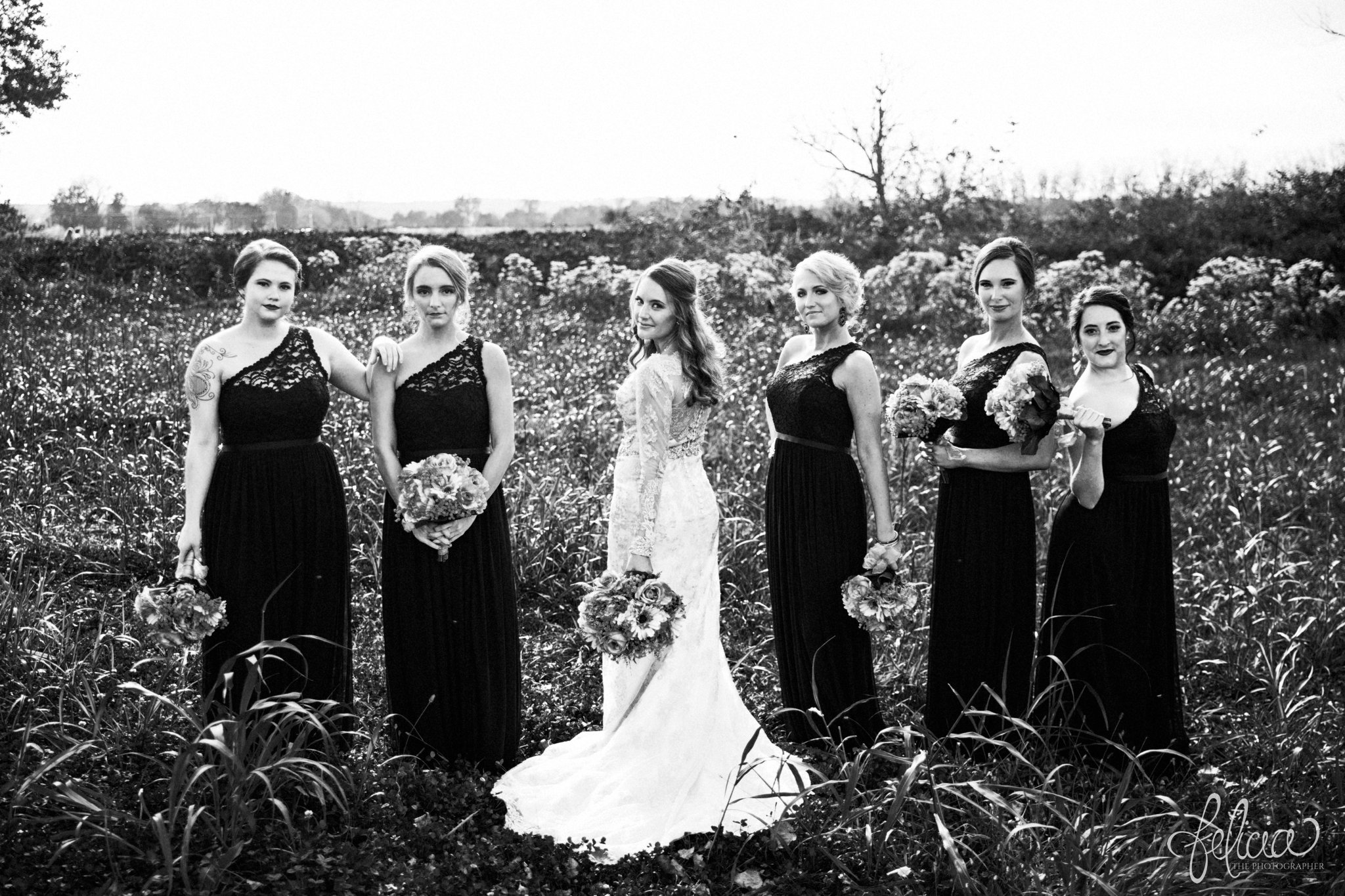black and white | weddings | wedding photos | wedding photography | images by feliciathephotographer.com | St. Therese Catholic Church | Kansas City | downtown | The Terrace on Grand | bridal party portraits | grassy field | field | nature | bridesmaid portraits | black bridesmaid dresses | bridesmaids with the bride | sassy poses | strong poses 