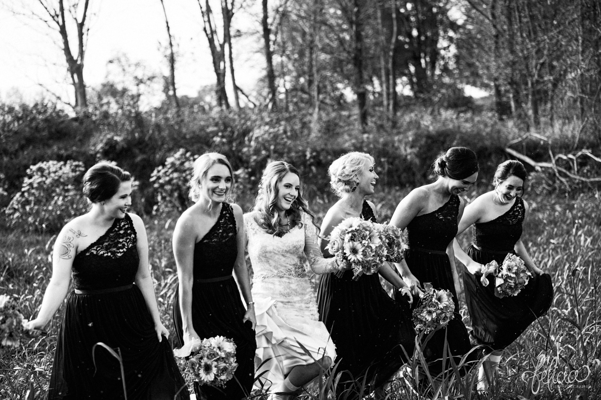 black and white | weddings | wedding photos | wedding photography | images by feliciathephotographer.com | St. Therese Catholic Church | Kansas City | downtown | The Terrace on Grand | bridal party portraits | grassy field | field | nature | bridesmaid portraits | black bridesmaid dresses | bridesmaids with the bride | candid 