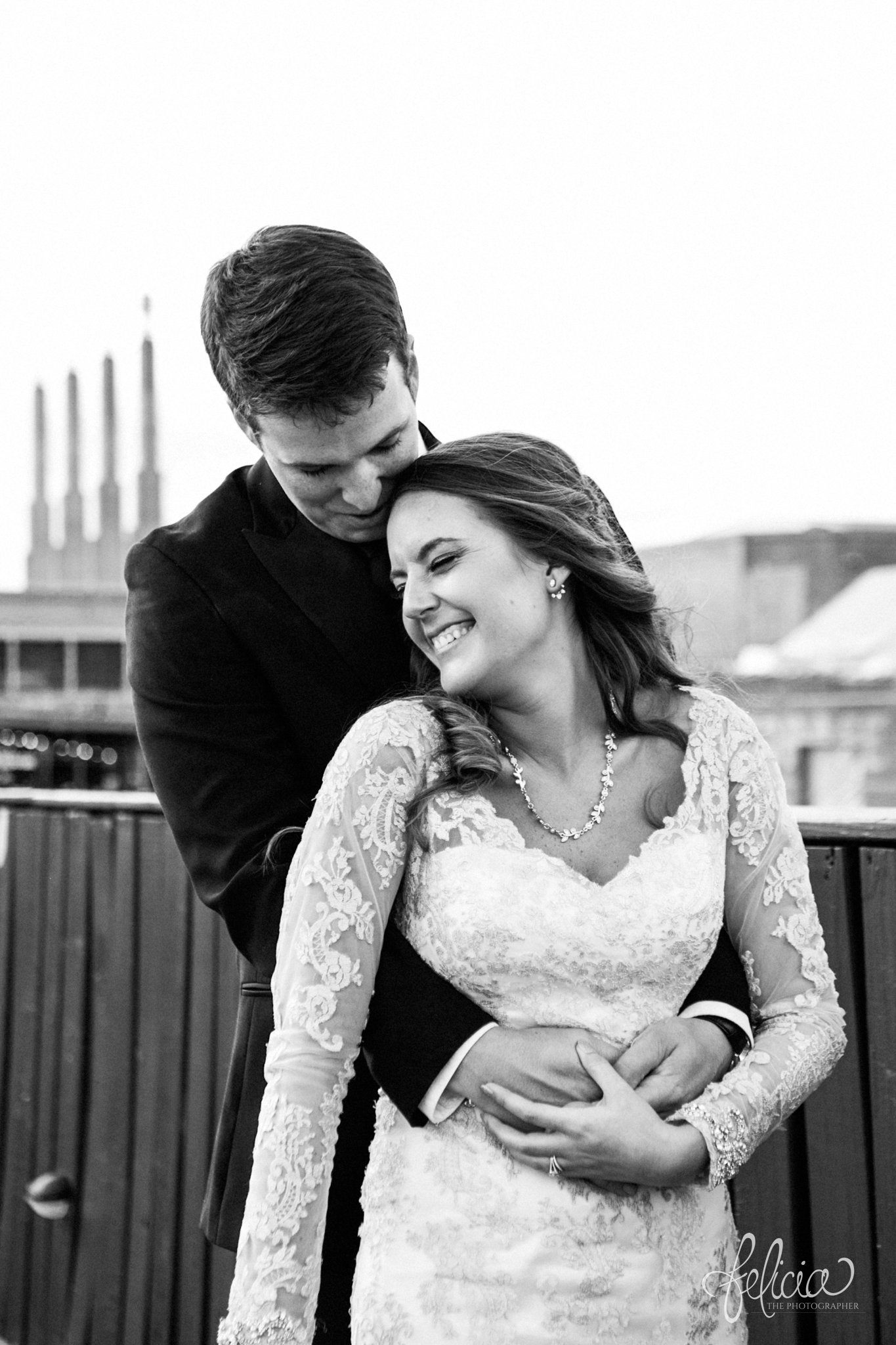 black and white | weddings | wedding photos | wedding photography | images by feliciathephotographer.com | St. Therese Catholic Church | Kansas City | downtown | The Terrace on Grand | bridal party portraits | urban jungle | downtown skyline | bride and groom portrait | rooftop photo | romantic pose | Kansas City Performing Arts Center | candid | laughing bride 
