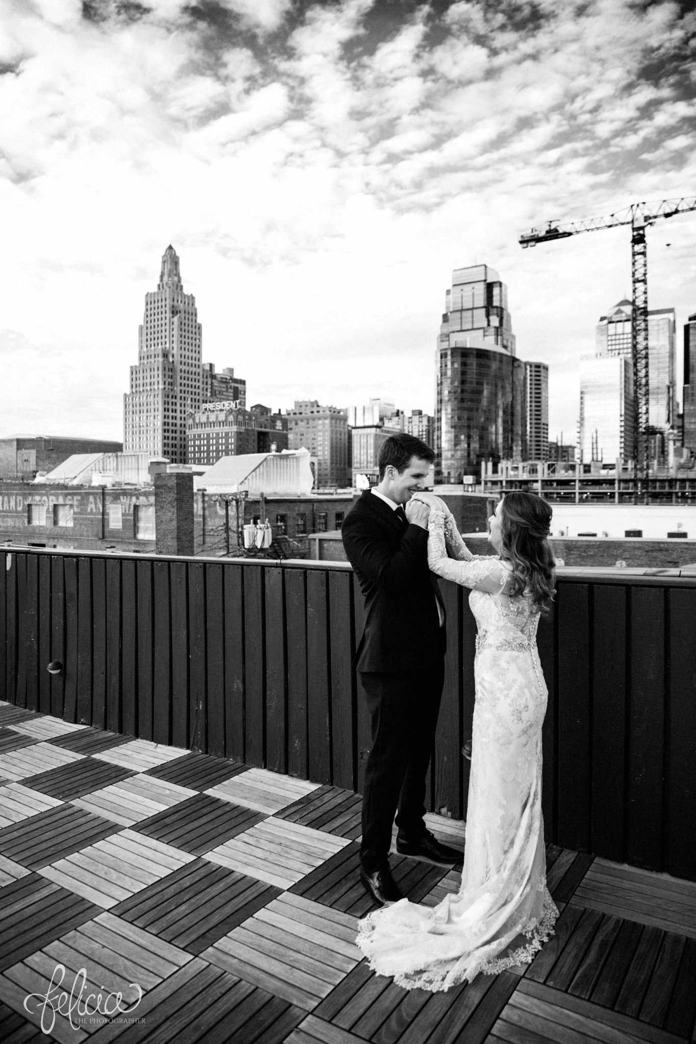 black and white | weddings | wedding photos | wedding photography | images by feliciathephotographer.com | St. Therese Catholic Church | Kansas City | downtown | The Terrace on Grand | bridal party portraits | urban jungle | Kansas City skyline | bride and groom portrait | rooftop photo | hand kiss 