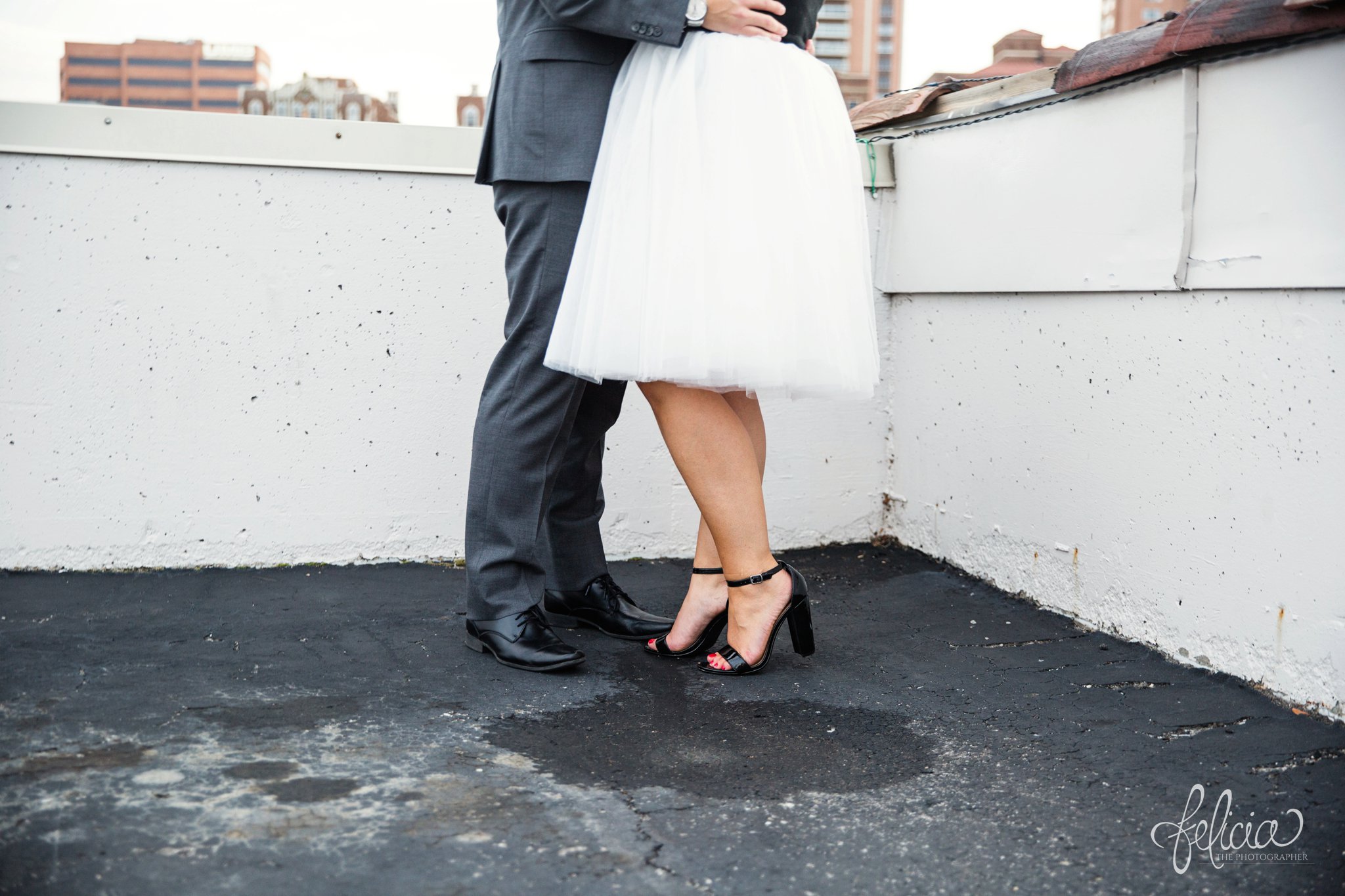 engagement photos | engagement photography | Kansas City | images by feliciathephotographer.com | architectural backgrounds | downtown | downtown Kansas City | fountain | Plaza Country Club | rooftop | terracotta | waist down | white tulle | black tie event 