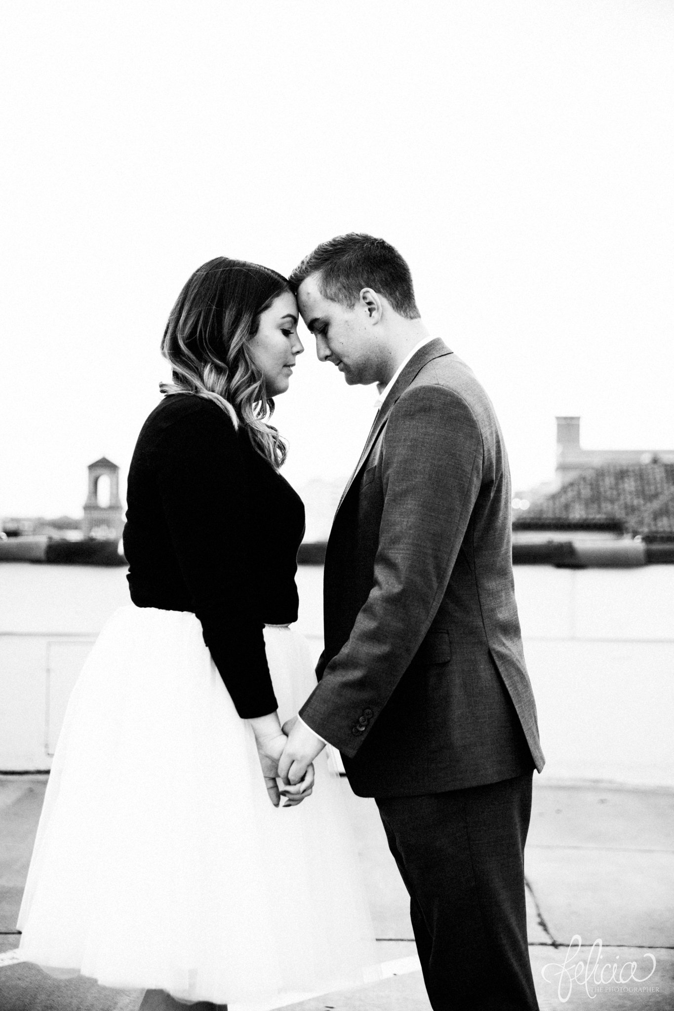 black and white | engagement photos | engagement photography | Kansas City | images by feliciathephotographer.com | architectural backgrounds | downtown | downtown Kansas City | fountain | Plaza Country Club | rooftop | terracotta | holding hands | forehead touch 