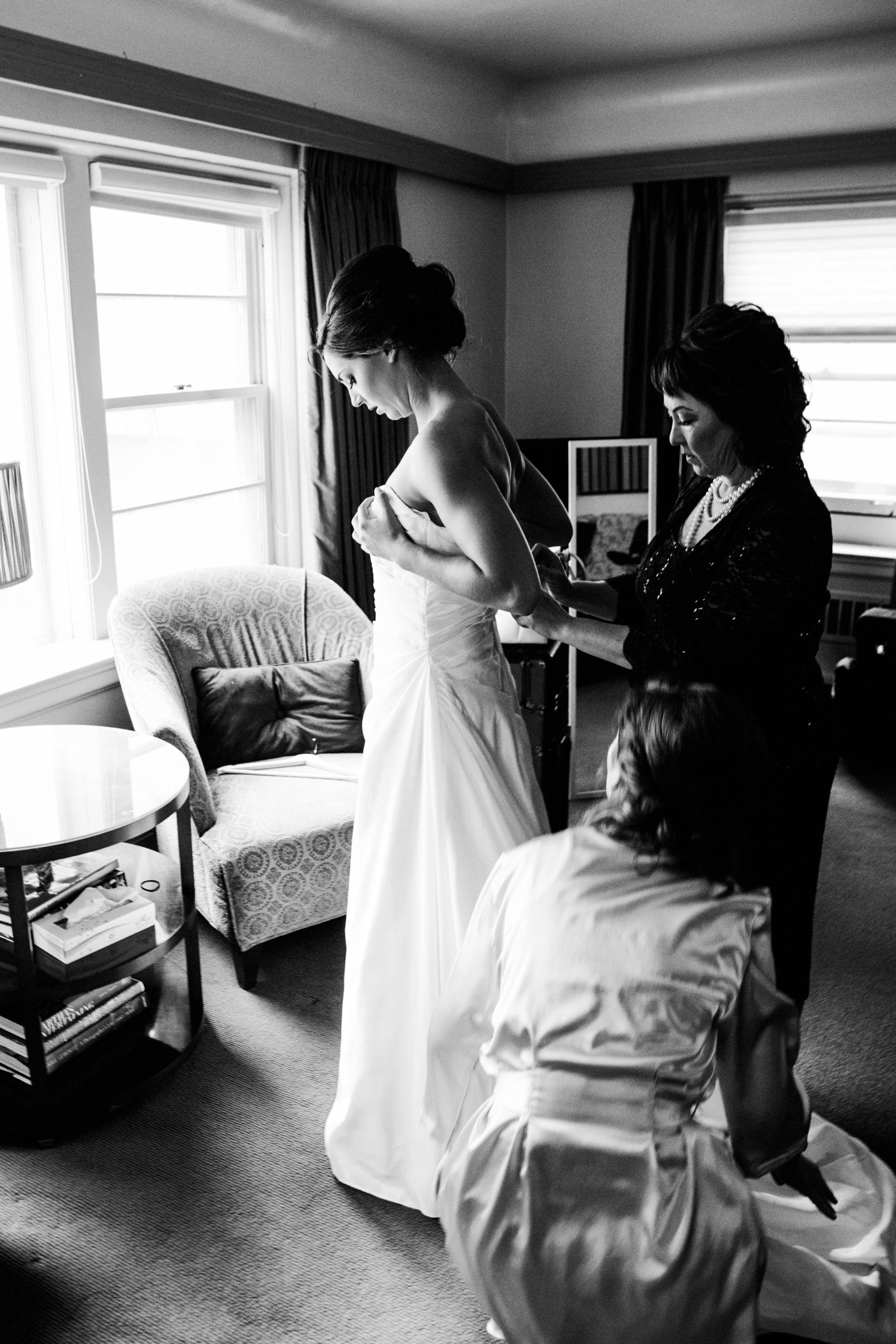black and white | wedding | wedding photos | wedding photography | images by feliciathephotographer.com | Country Club Plaza | Kansas City | Unity Temple | wedding prep | getting ready | candid | stepping into dress | David's Bridal | mother of the bride | mother with bride 