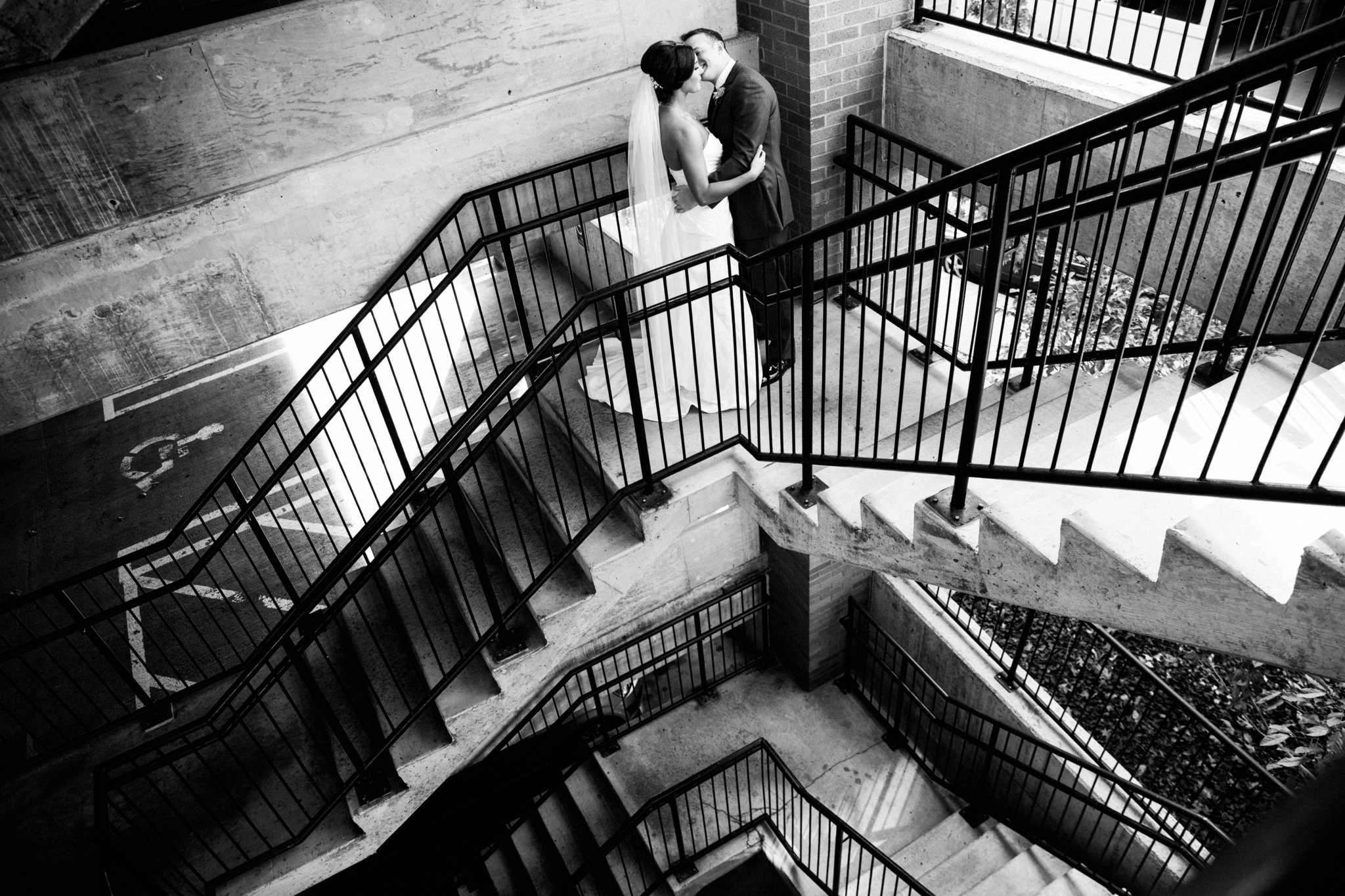 black and white | wedding | wedding photos | wedding photography | images by feliciathephotographer.com | Country Club Plaza | Kansas City | Unity Temple | first look | bride and groom | staircase meeting | groom reaction | embrace | kisses 