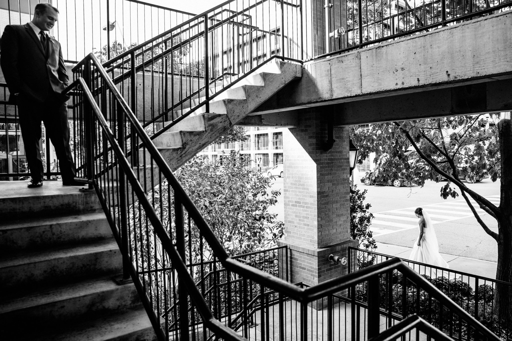 black and white | wedding | wedding photos | wedding photography | images by feliciathephotographer.com | Country Club Plaza | Kansas City | Unity Temple | first look | groom solo shot | staircase meeting | groom reaction 