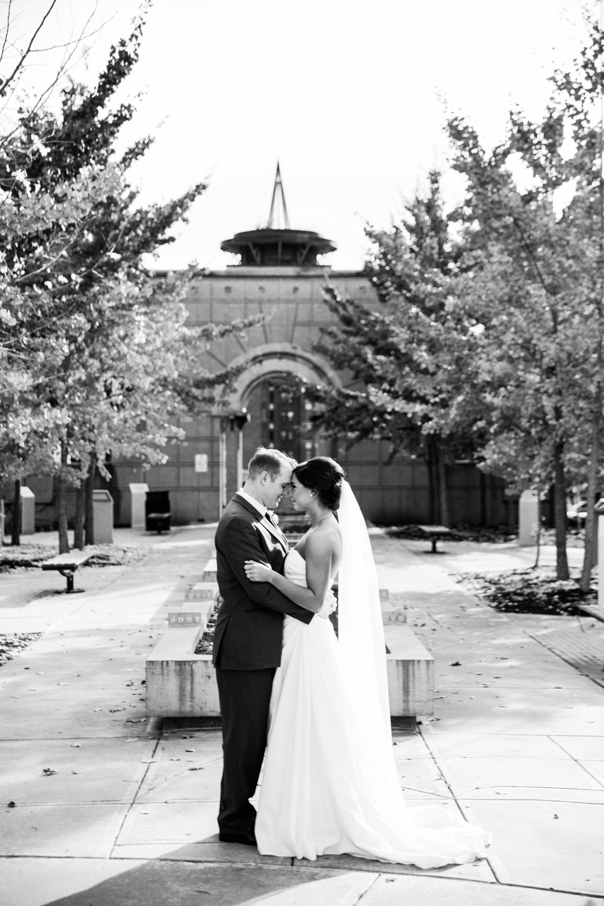 black and white | wedding | wedding photos | wedding photography | images by feliciathephotographer.com | Country Club Plaza | Kansas City | Unity Temple | Cancer Survivor Park | bride and groom portraits | candid | laughing bride | David's Bridal | forehead touches 
