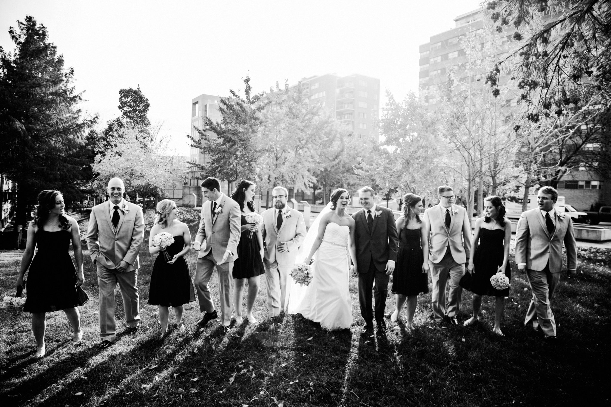 black and white | wedding | wedding photos | wedding photography | images by feliciathephotographer.com | Country Club Plaza | Kansas City | Unity Temple | Cancer Survivor Park | bridal party portraits | navy bridesmaid dresses | walking in the park | candid 