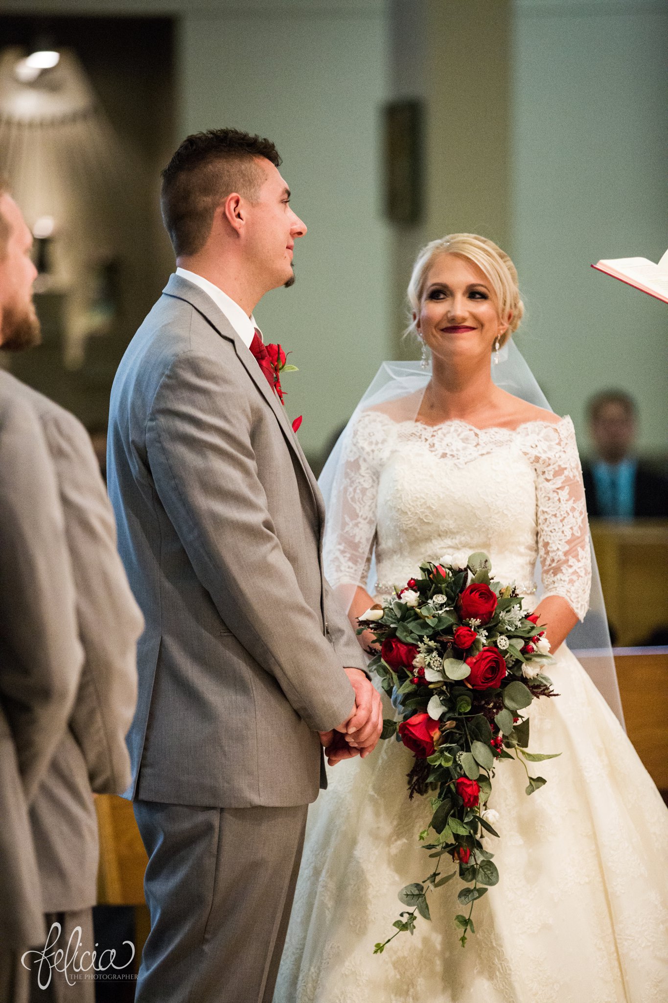 wedding | wedding photography | wedding photos | Kansas City | St. Patrick's Catholic Church | Hawthorne House | images by feliciathephotographer.com | crimson wedding | Christmas Wedding | ceremony | red and green bouquet | bride and groom at altar 