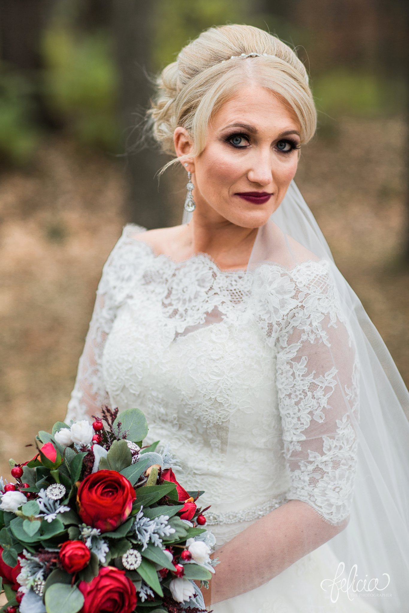 wedding | wedding photography | wedding photos | Kansas City | St. Patrick's Catholic Church | Hawthorne House | images by feliciathephotographer.com | crimson wedding | Christmas Wedding | winter portraits | nature background | bride portrait | dramatic veil | bride solo shot | winter bouquet | dramatic pose | red roses | lace sleeves | lace wedding dress | Paula Varsalona