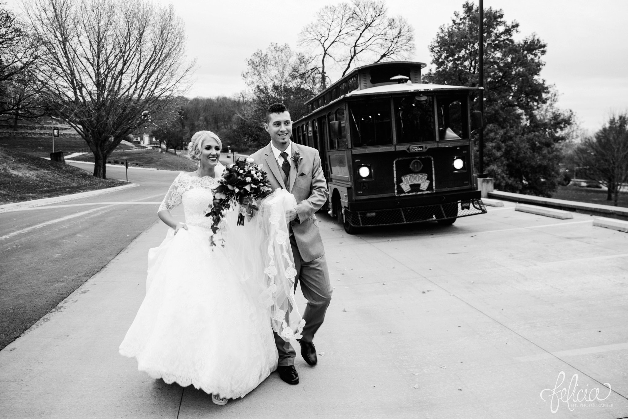 black and white | wedding | wedding photography | wedding photos | Kansas City | St. Patrick's Catholic Church | Hawthorne House | images by feliciathephotographer.com | crimson wedding | Christmas Wedding | winter portraits | dramatic veil | lace sleeves | lace wedding dress | Paula Varsalona | candid | bride and groom | trolley 