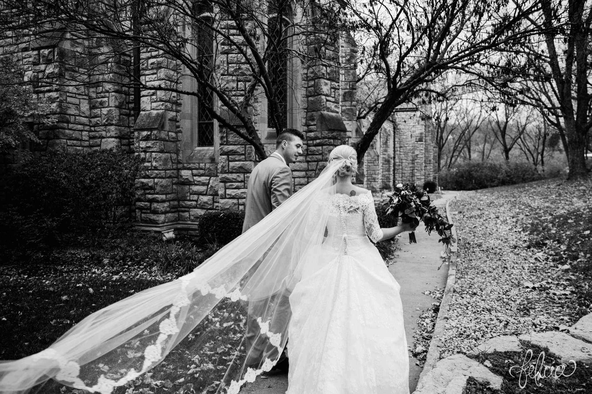 black and white | wedding | wedding photography | wedding photos | Kansas City | St. Patrick's Catholic Church | Hawthorne House | images by feliciathephotographer.com | crimson wedding | Christmas Wedding | winter portraits | dramatic veil | lace sleeves | lace wedding dress | Paula Varsalona | candid | bride and groom | church background | stone background 