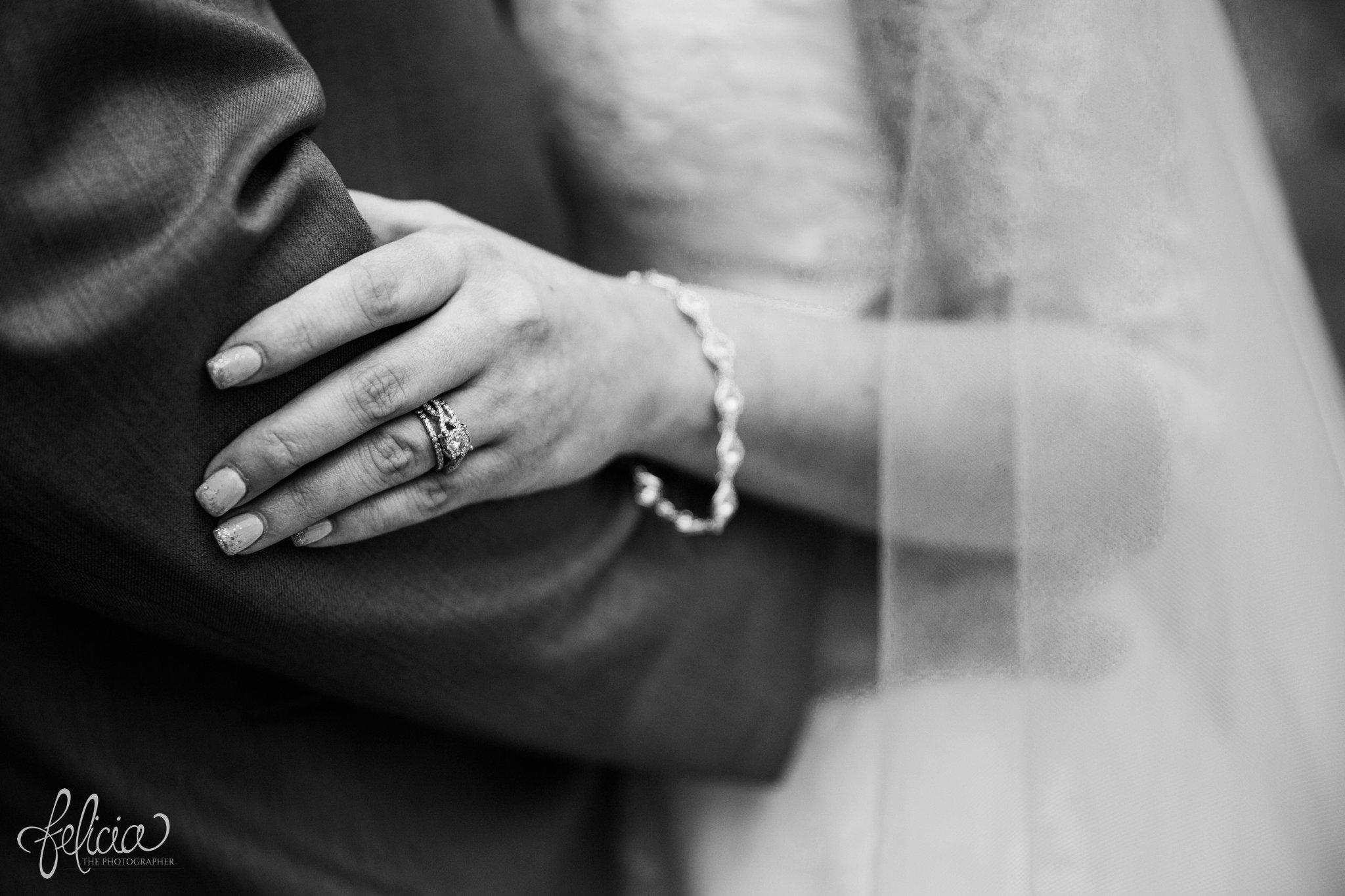 black and white | wedding | wedding photography | wedding photos | Kansas City | St. Patrick's Catholic Church | Hawthorne House | images by feliciathephotographer.com | crimson wedding | Christmas Wedding | winter portraits | dramatic veil | lace sleeves | lace wedding dress | Paula Varsalona | bride and groom | embrace | wedding rings | Hannoush Jewelers