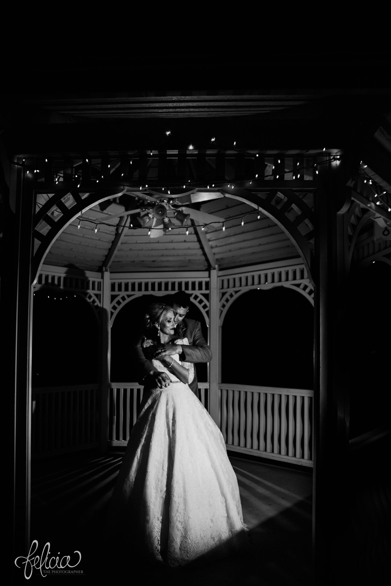 wedding | wedding photography | wedding photos | Kansas City | Hawthorne House | images by feliciathephotographer.com | crimson wedding | Christmas Wedding | night portrait | bride and groom | romantic pose | embrace | gazebo | romance | Christmas lights | Paula Varsalona