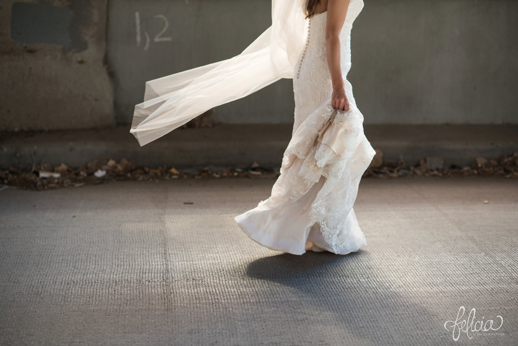 wedding | wedding photos | industrial | Rumely Event Space | wedding photography | images by feliciathephotographer.com | West Bottoms | first look | Maggie Sottero | wedding dress train | walking bride | walking toward groom | industrial background