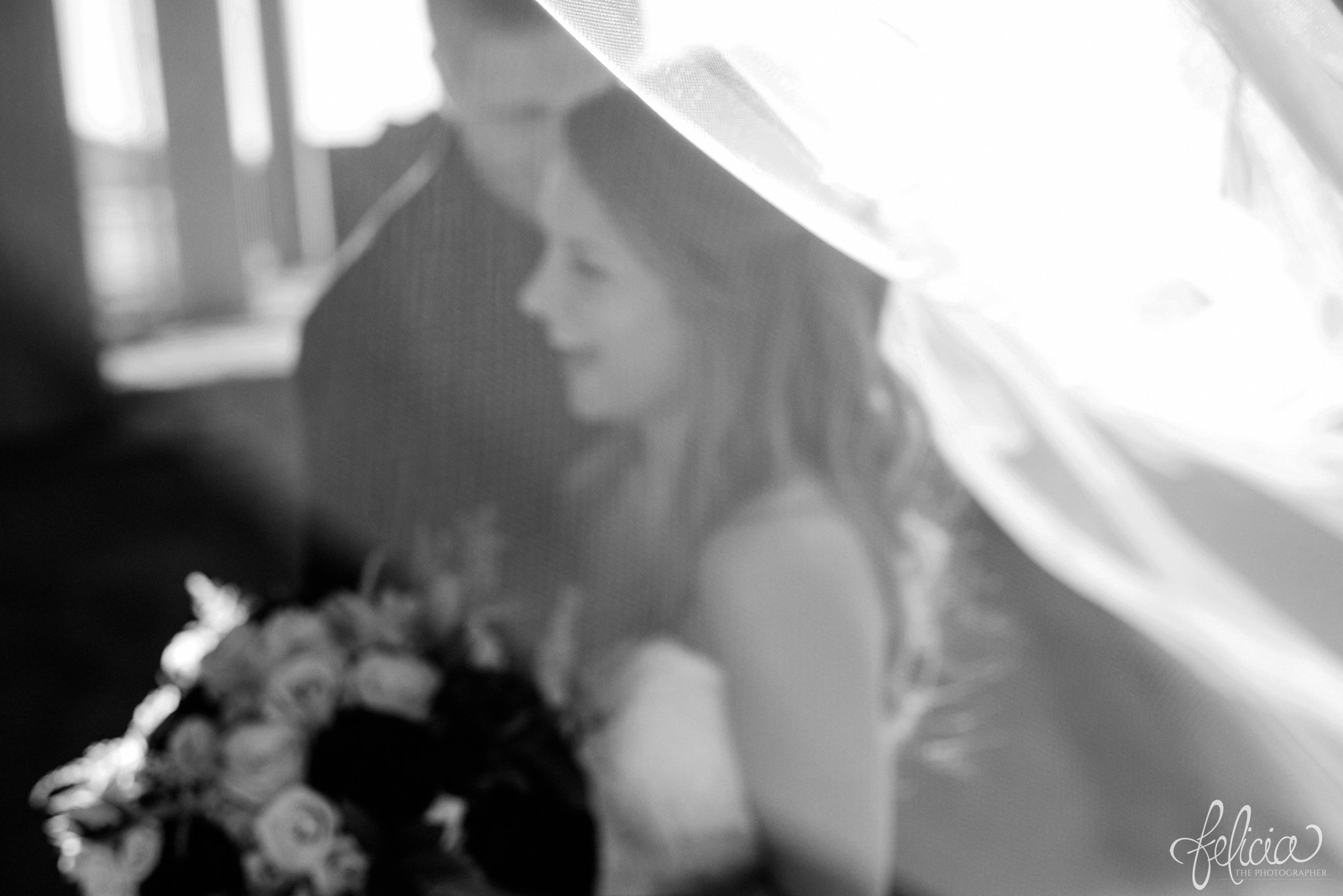 black and white | wedding | wedding photos | industrial | Rumely Event Space | wedding photography | images by feliciathephotographer.com | West Bottoms | industrial background | bride and groom portraits | bride silhouette | veil | unfocused | candid | laughing 