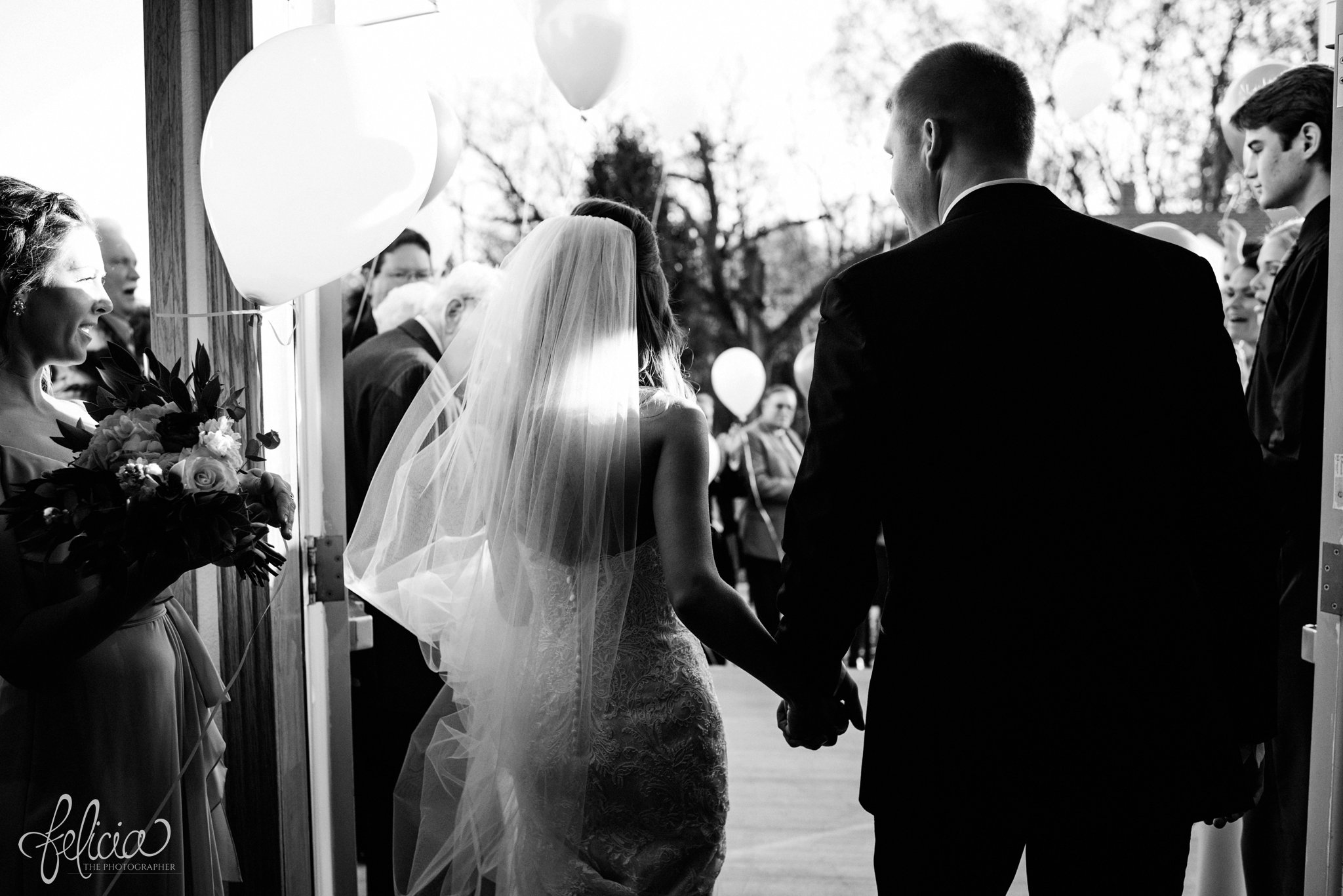 black and white | wedding | wedding photos | industrial | Rumely Event Space | wedding photography | images by feliciathephotographer.com | West Bottoms | wedding ceremony | The Providence Baptist Church | bride and groom | Mr. and Mrs. | walking down the aisle | exiting the church | open church doors | holding hands 