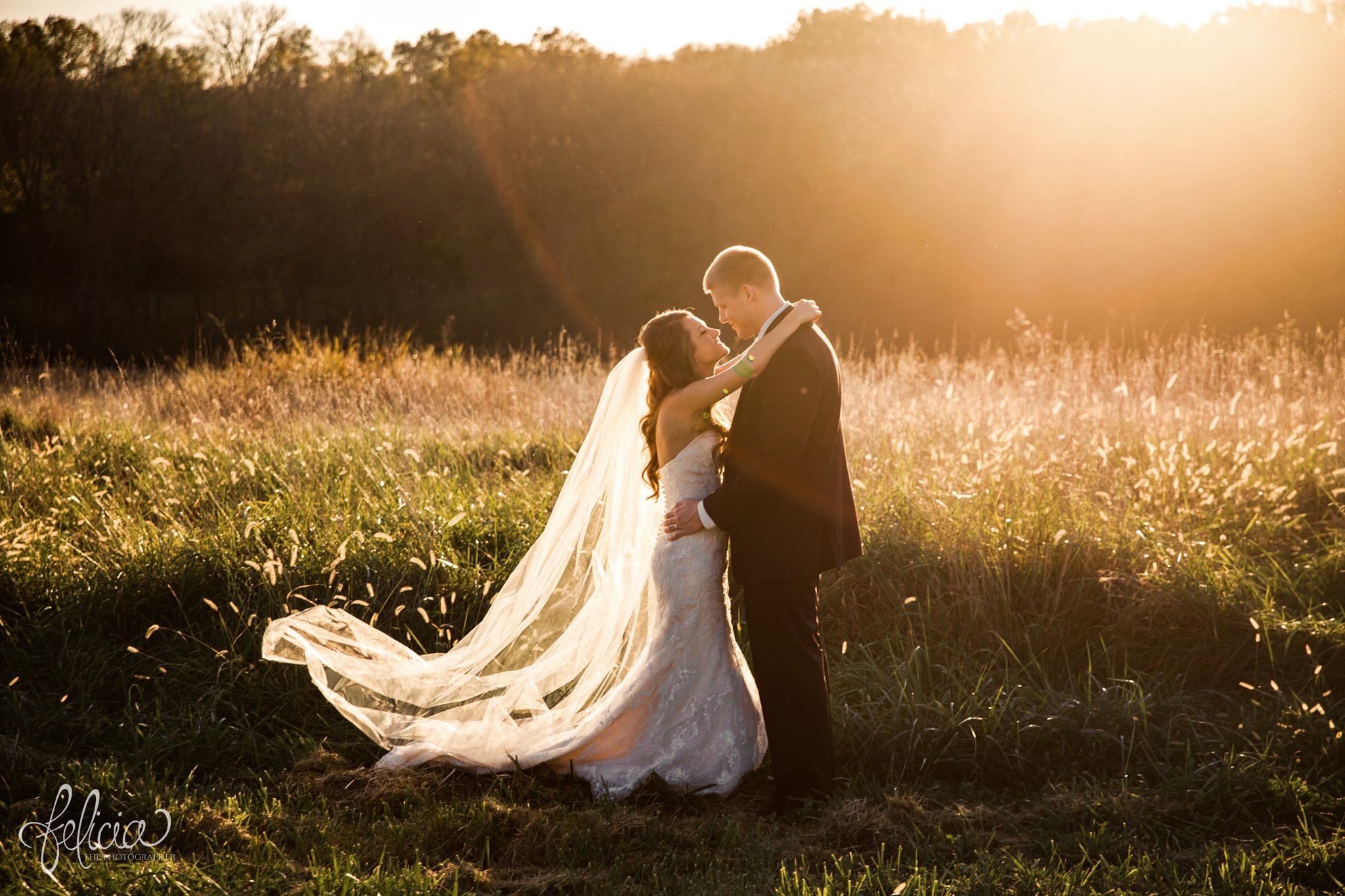 wedding | wedding photos | Rumely Event Space | wedding photography | images by feliciathephotographer.com | field background | nature | nose touch | bride and groom portrait | holding hands | smiling | romantic pose | romantic sun | sun flare | embrace 