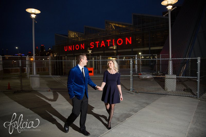 engagement photos | night engagement photos | Union Station | Kansas City | images by feliciathephotographer.com | romantic engagement | dramatic background | scallop neck dress | pearl accessories | blue blazer | Old Hollywood | holding hands 