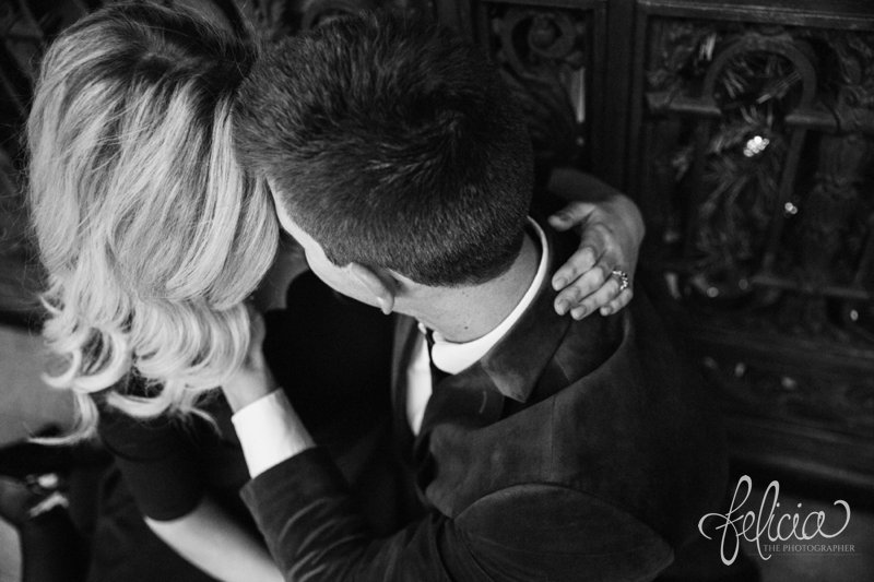 black and white | engagement photos | night engagement photos | Union Station | Kansas City | images by feliciathephotographer.com | romantic engagement | hugging pose | dramatic background | scallop neck dress | pearl accessories | blue blazer | romantic poses | intricate backgrounds | Old Hollywood | engagement kiss 