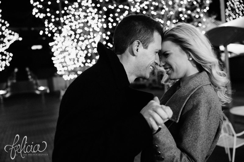 black and white | engagement photos | night engagement photos | Union Station | Kansas City | images by feliciathephotographer.com | romantic engagement | dramatic background | romantic poses | Old Hollywood | Christmas engagement photos | white lights | Christmas lights | dancing in the park | romantic pose | forehead touching | cobblestone | candid smiles | hand holding 